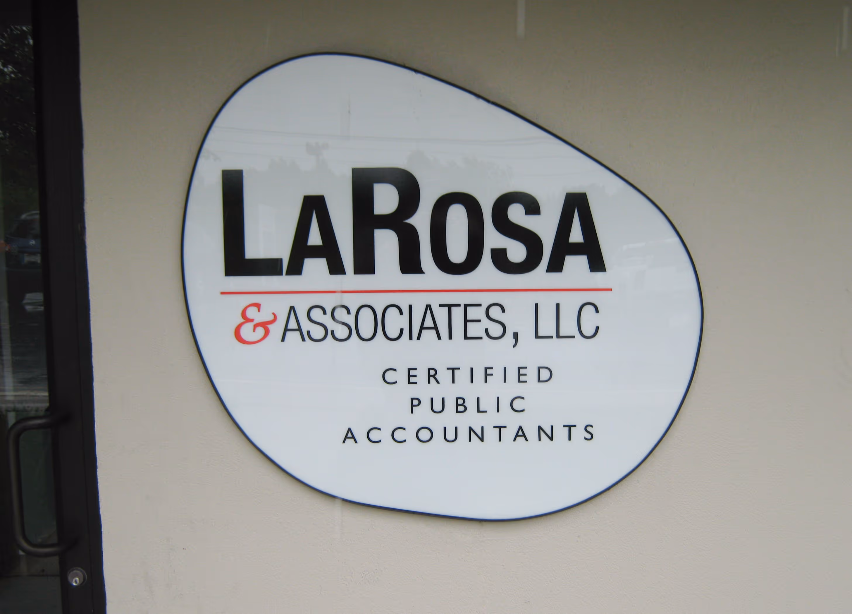 Custom-shaped acrylic panel with vinyl print of the company name and logo