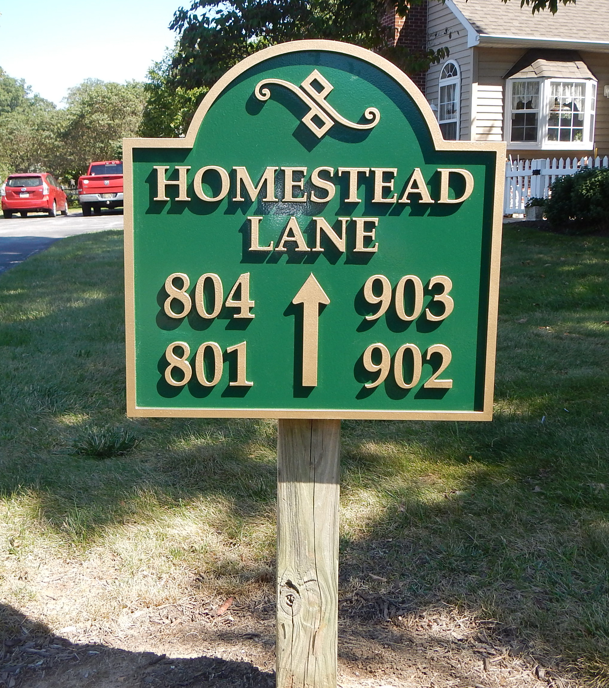 Carved HDU wayfinding sign in a neighborhood