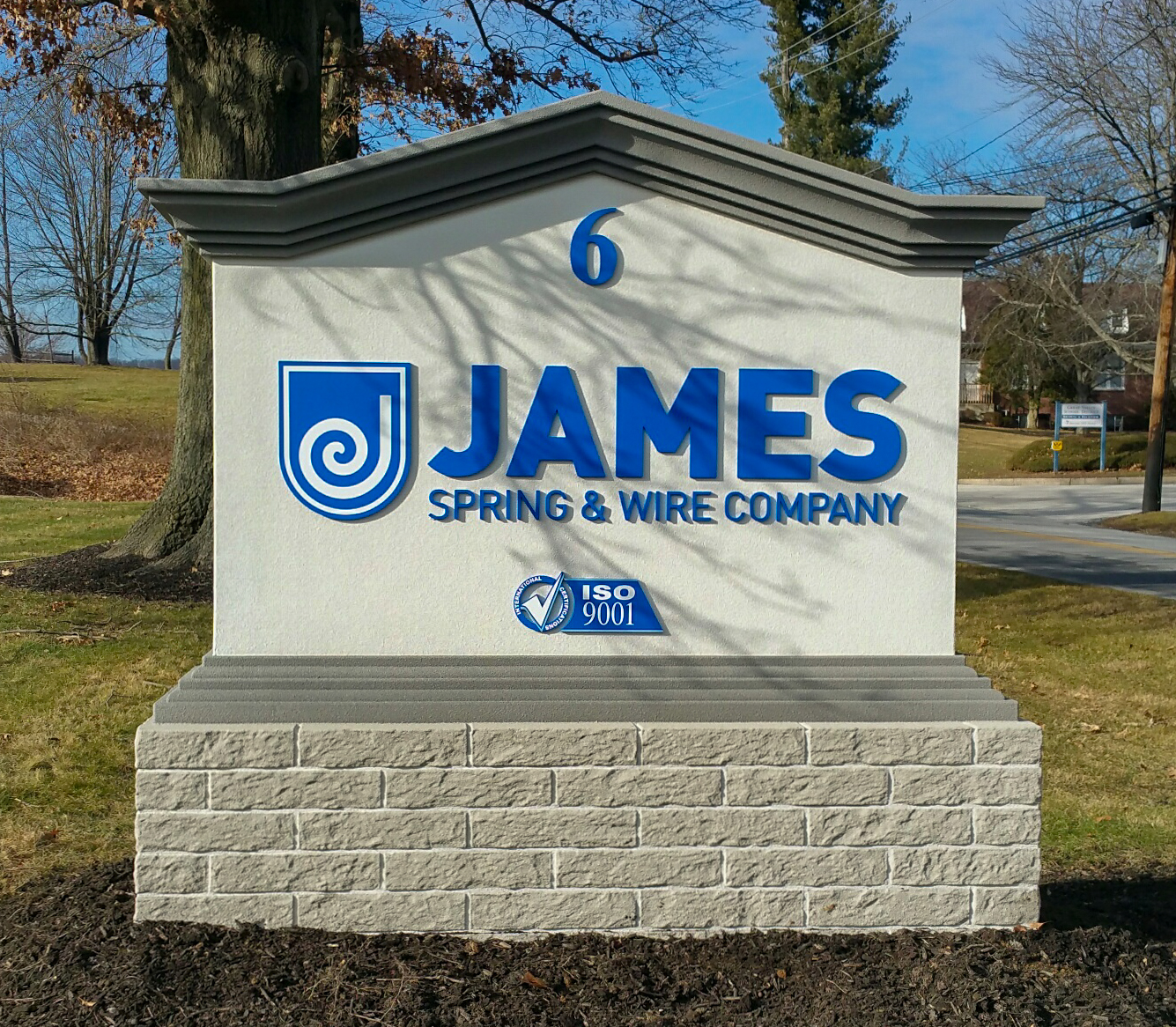 Blue dimensional letters on a masonry monument sign base