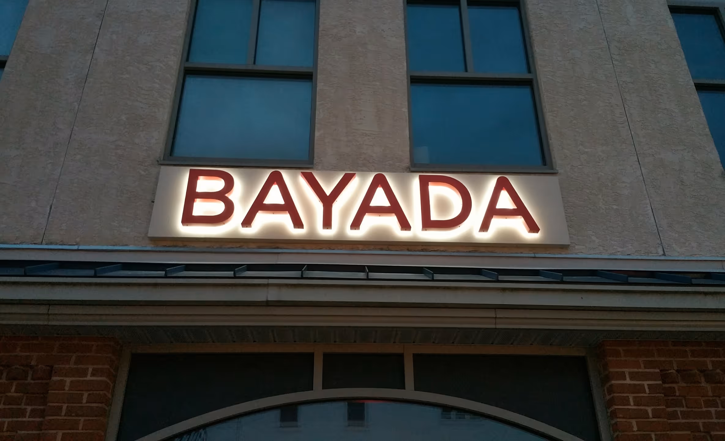 Red, halo-lit channel letters mounted on a pan