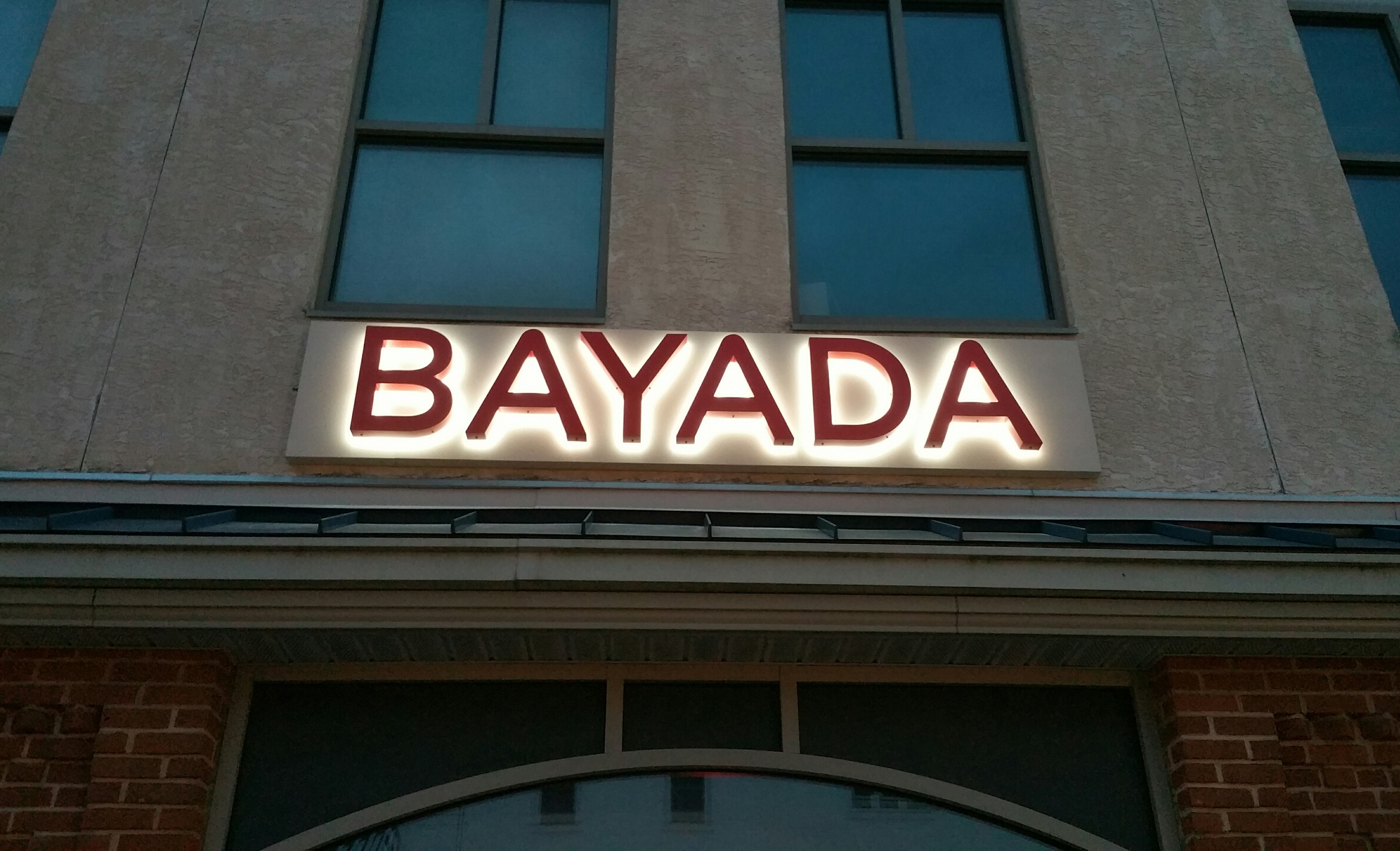 Red, halo-lit channel letters on the side of a building