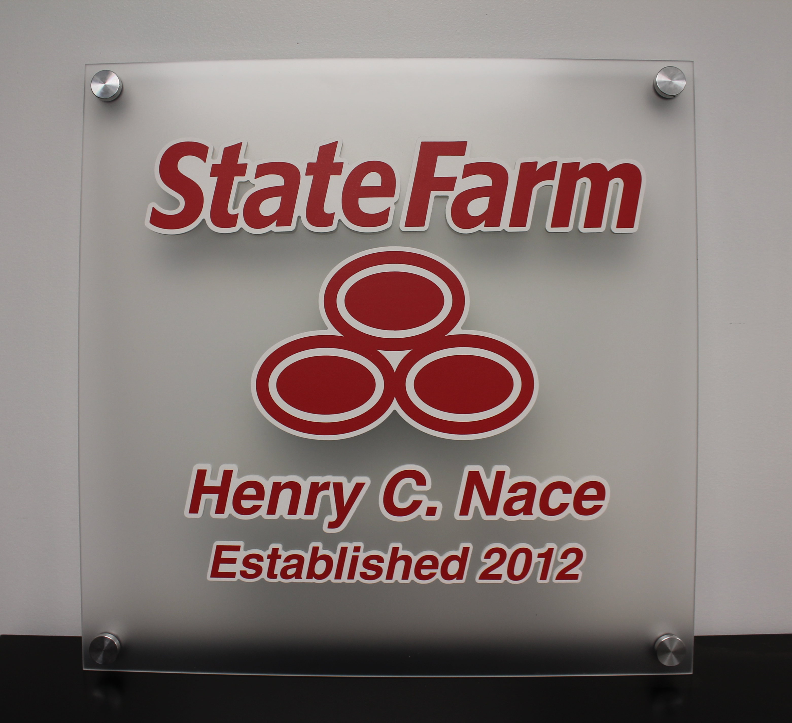 Plotted insurance company logo on an acrylic wall panel