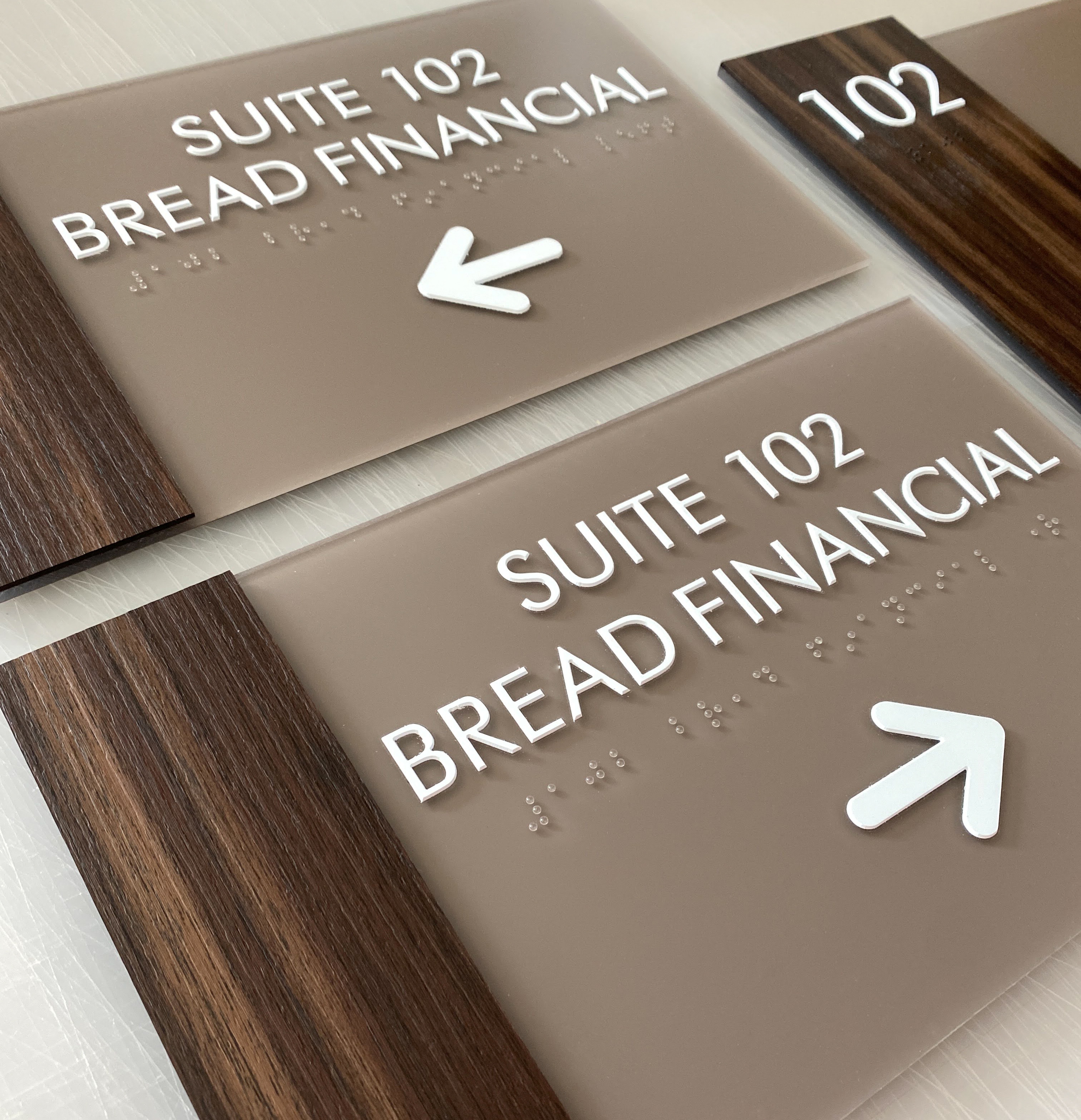 Custom ADA suite signs with faux wood and acrylic