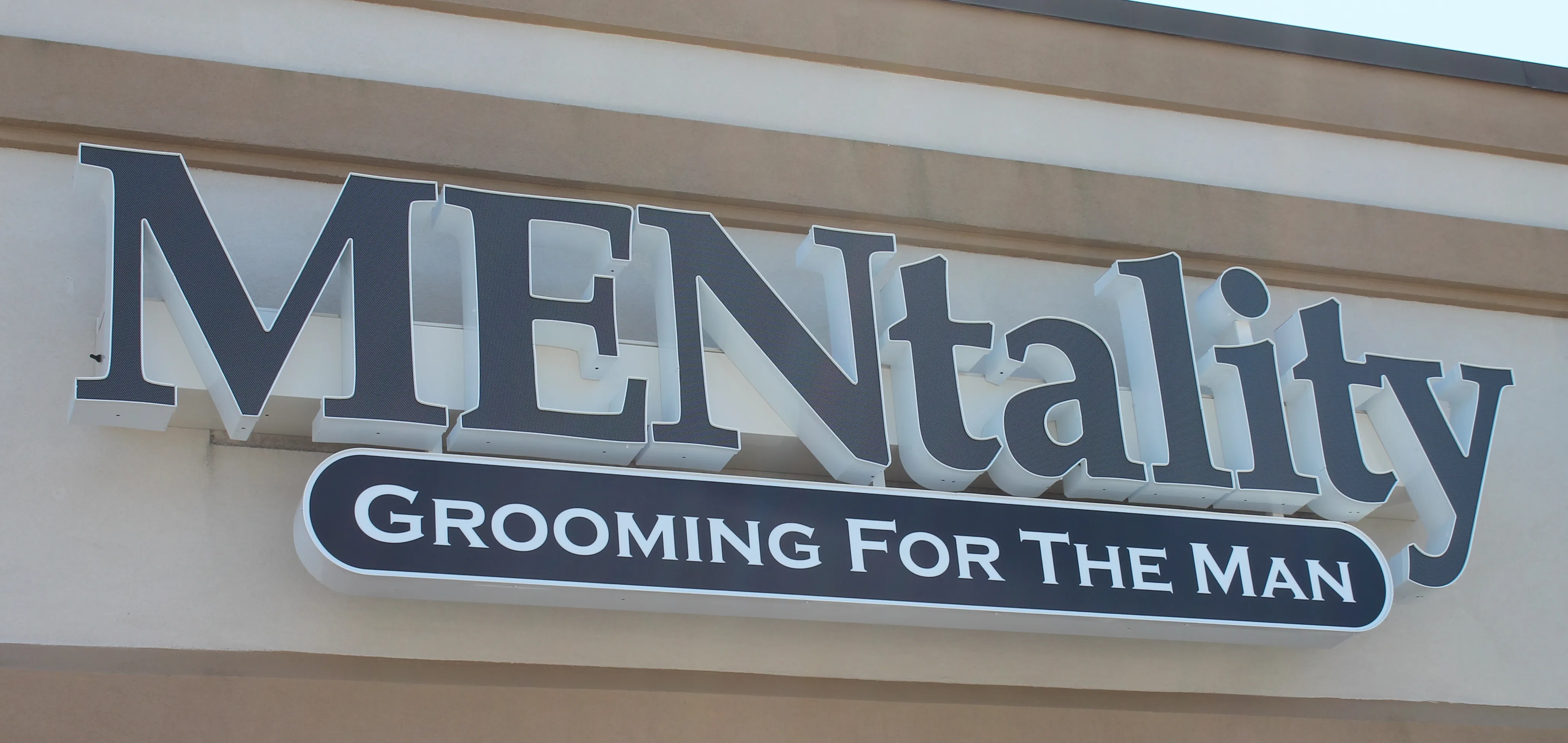 Navy blue channel letters installed on a racetrack