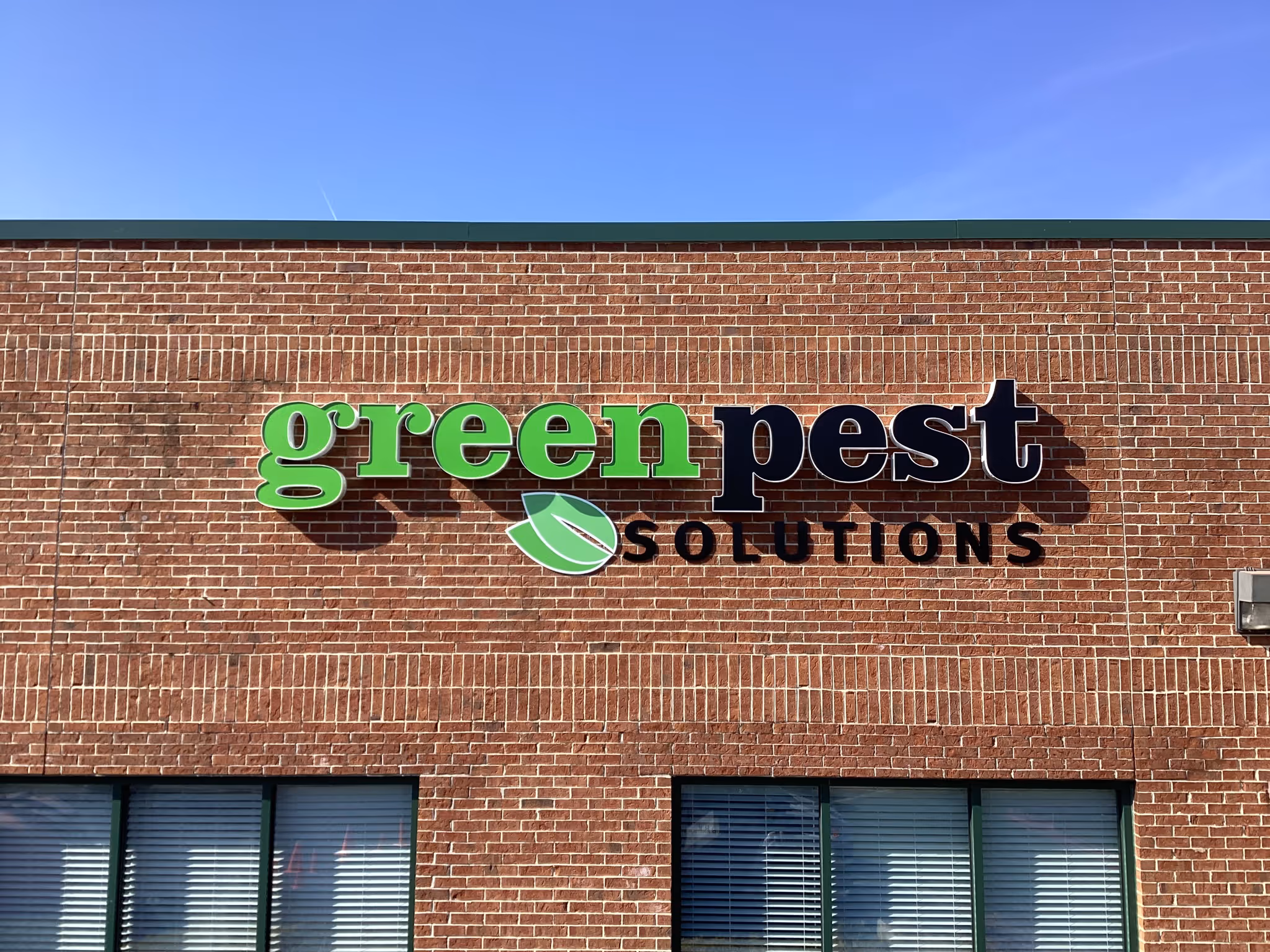 Green and black channel letters mounted on a exterior wall