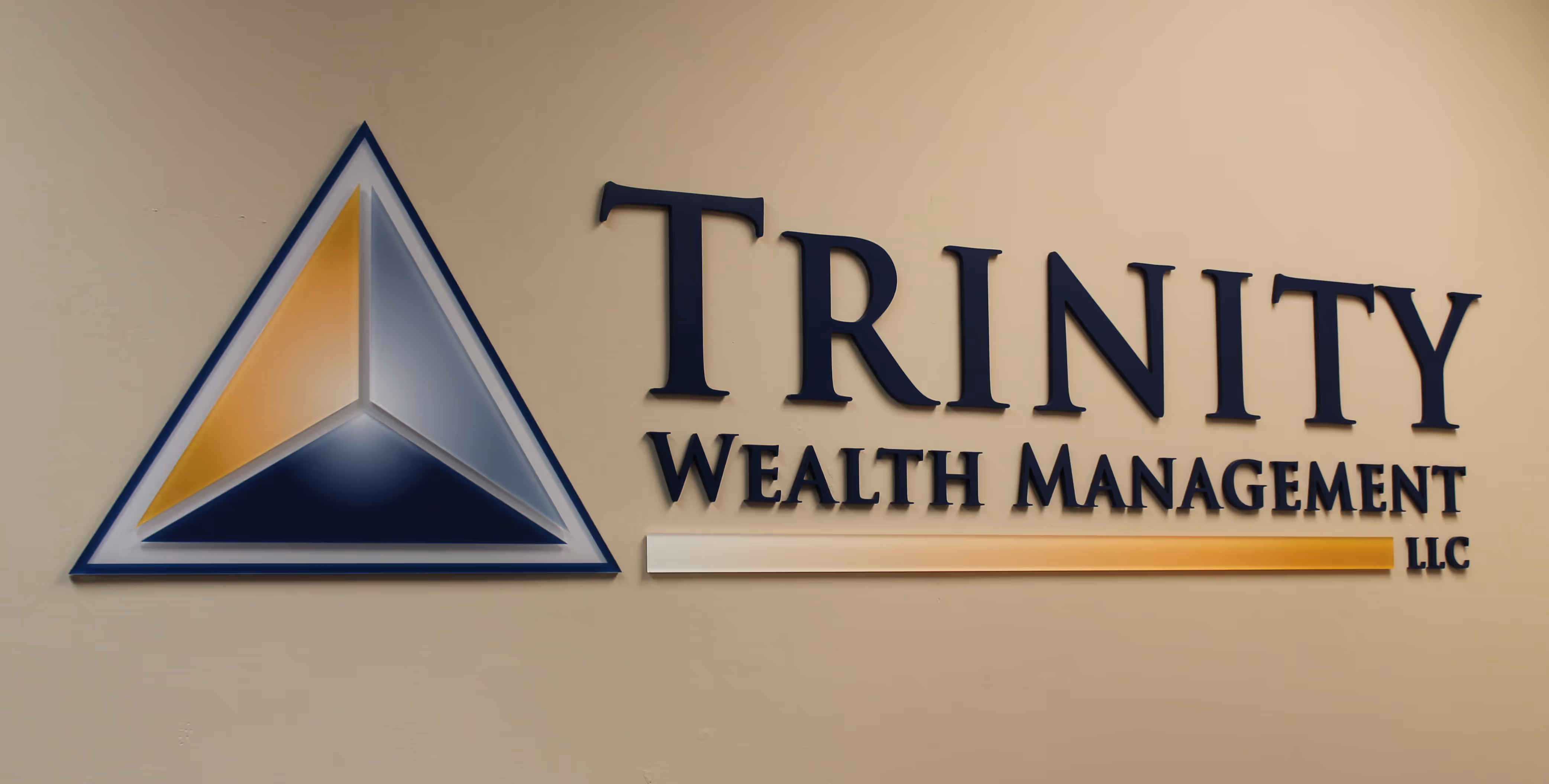 Painted acrylic dimensional letters mounted flush to a beige wall