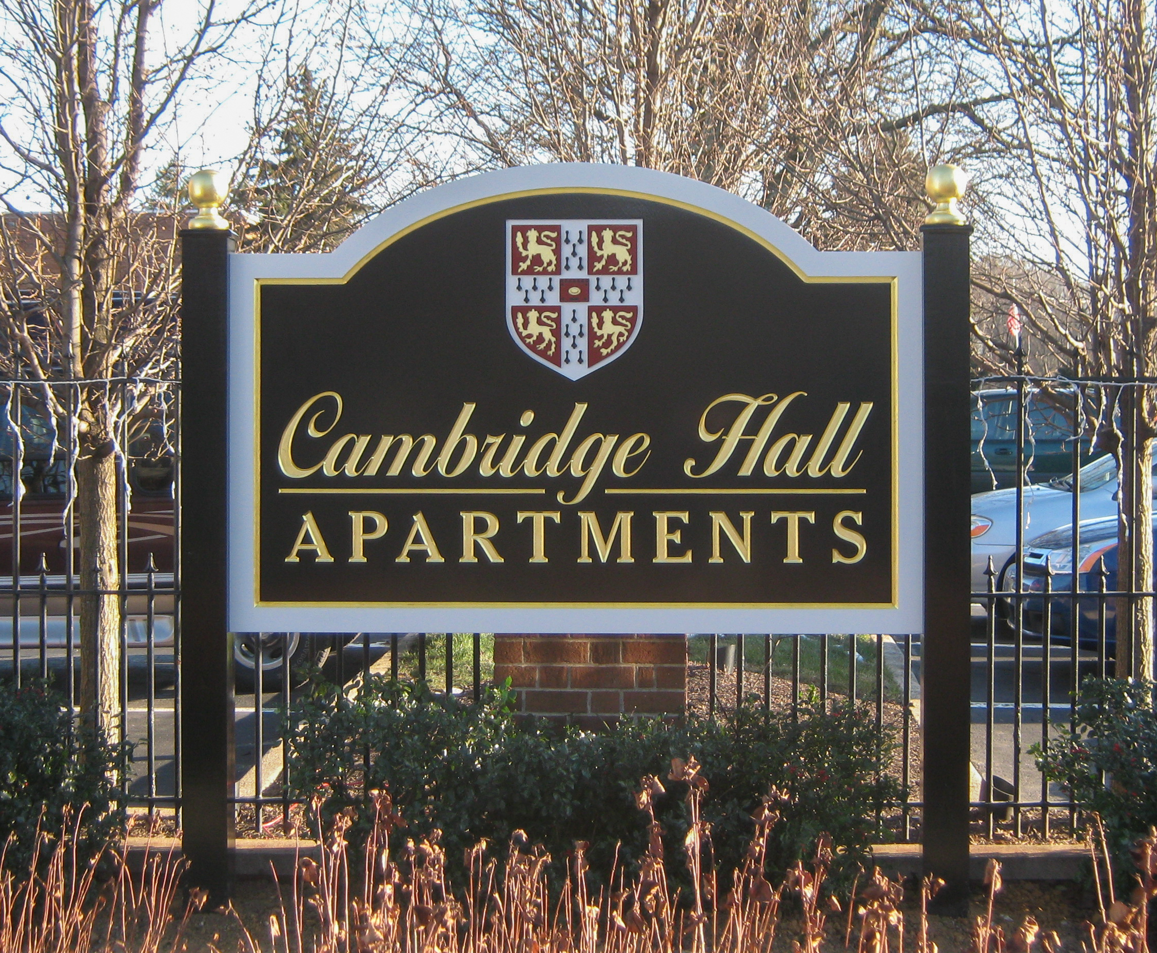 Multi-colored, custom-cut carved HDU signs between two black posts