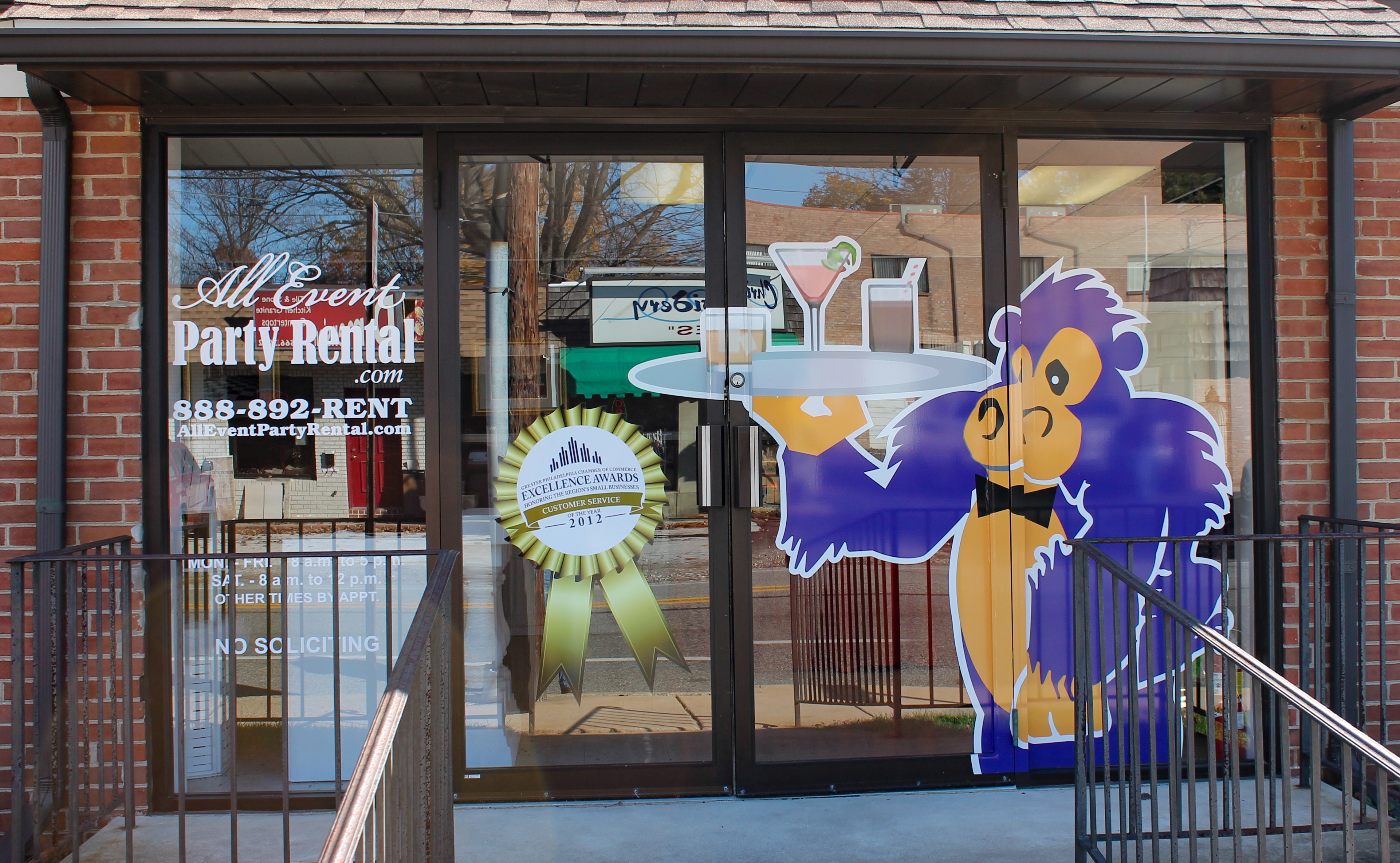 Vinyl letters and mascot image on a storefront window