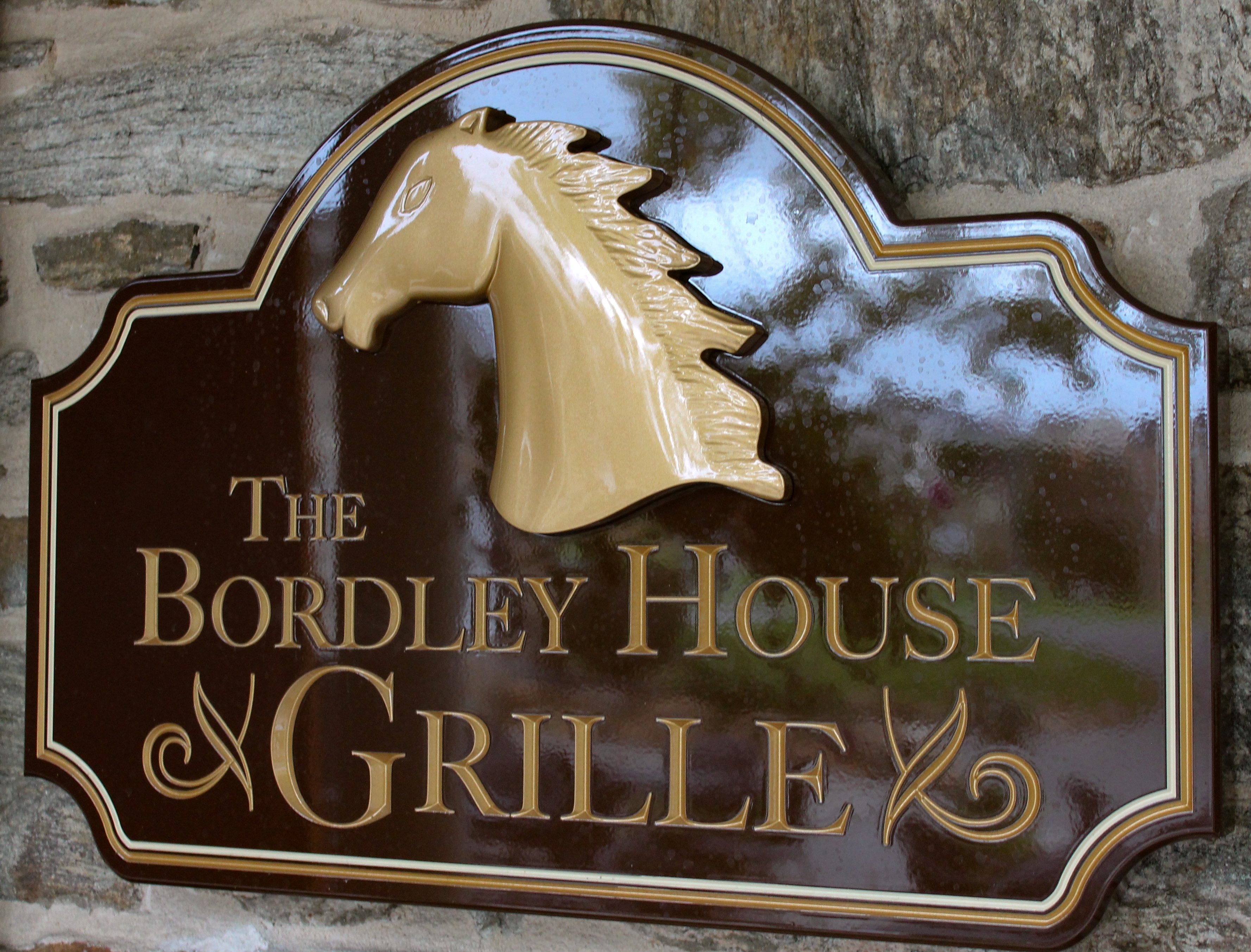 Custom-carved HDU sign with golden horse head logo
