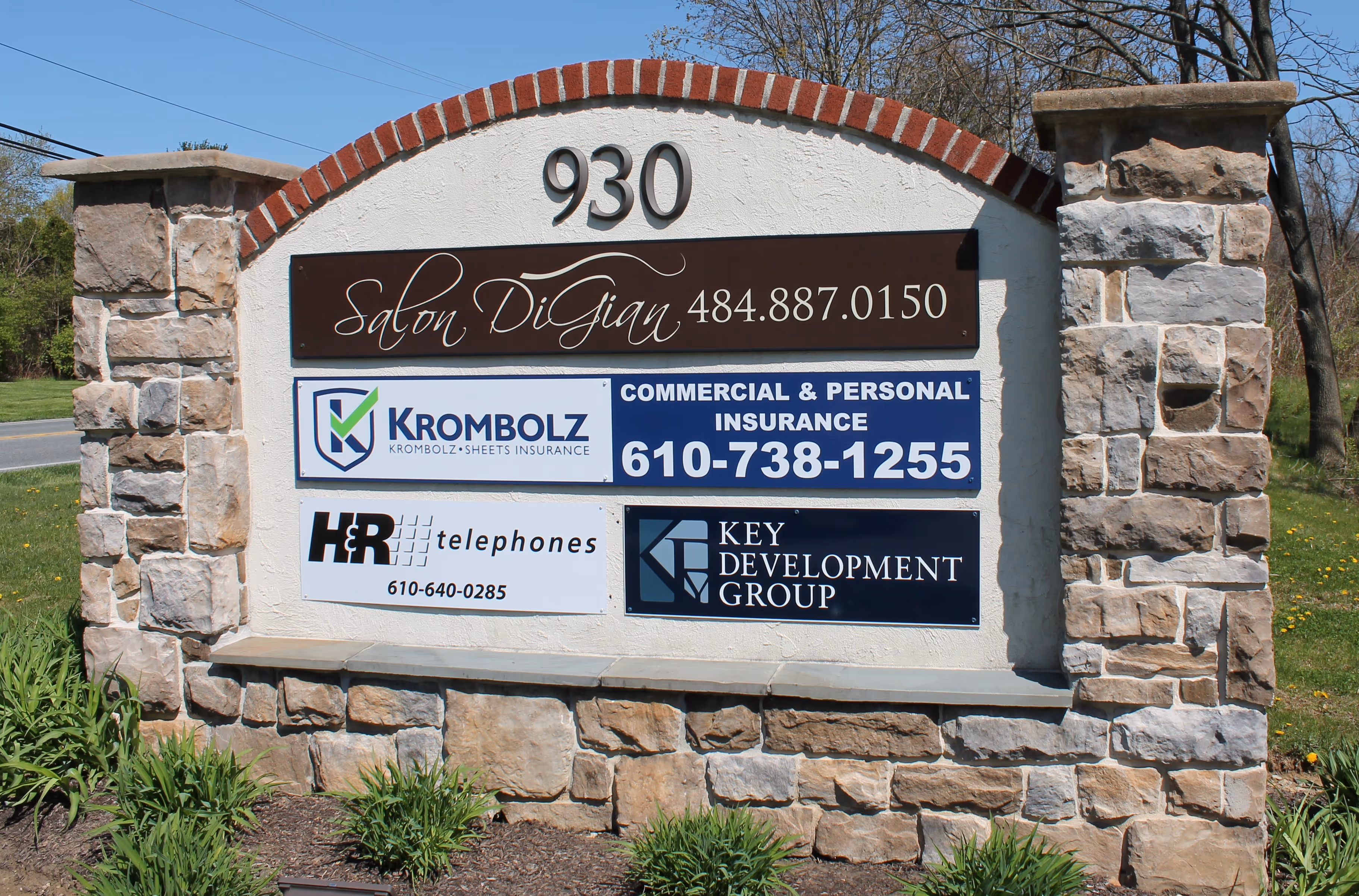 Stone monument sign with multi-tenant listing