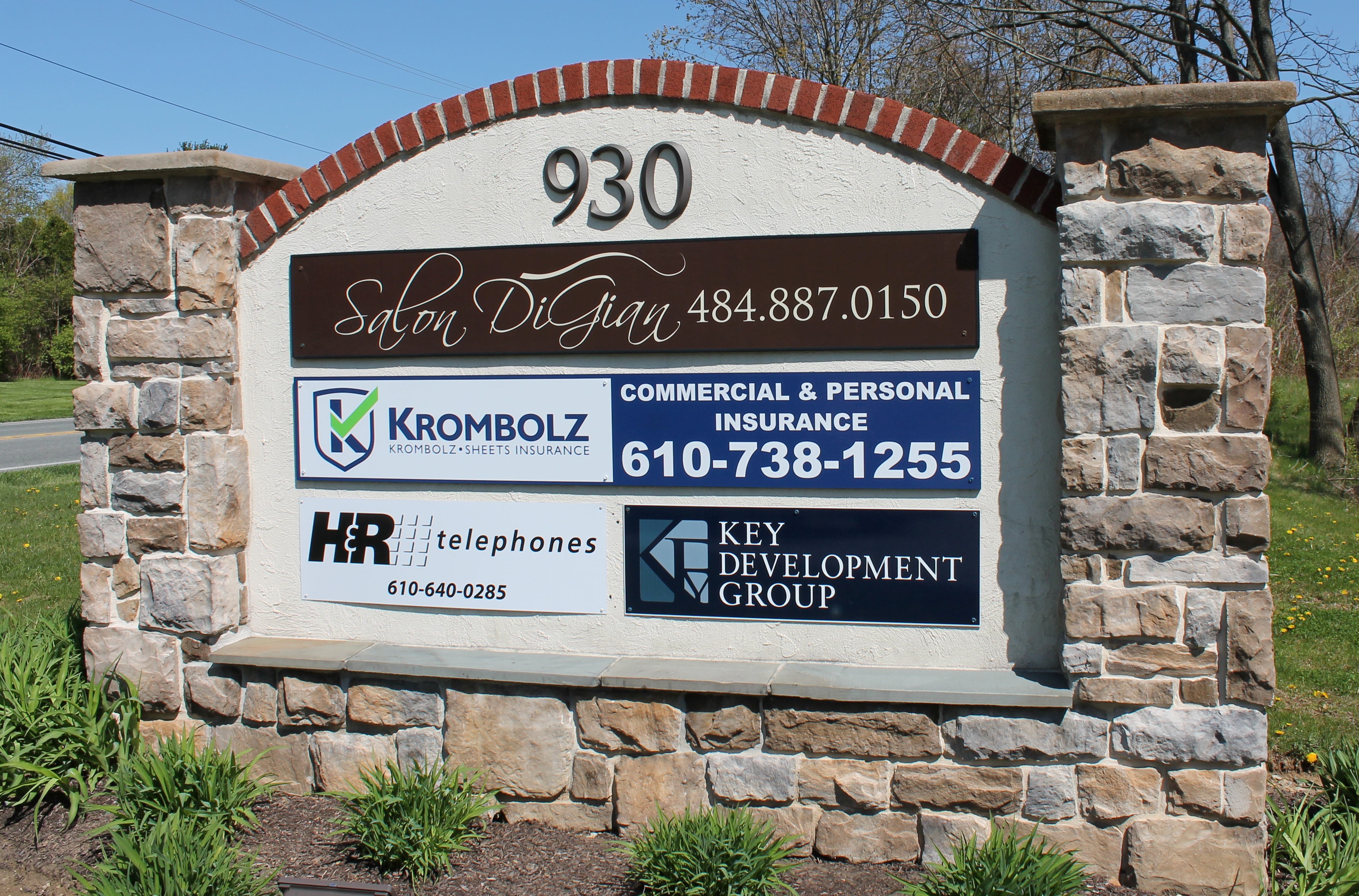 Stone monument sign with multi-tenant listing