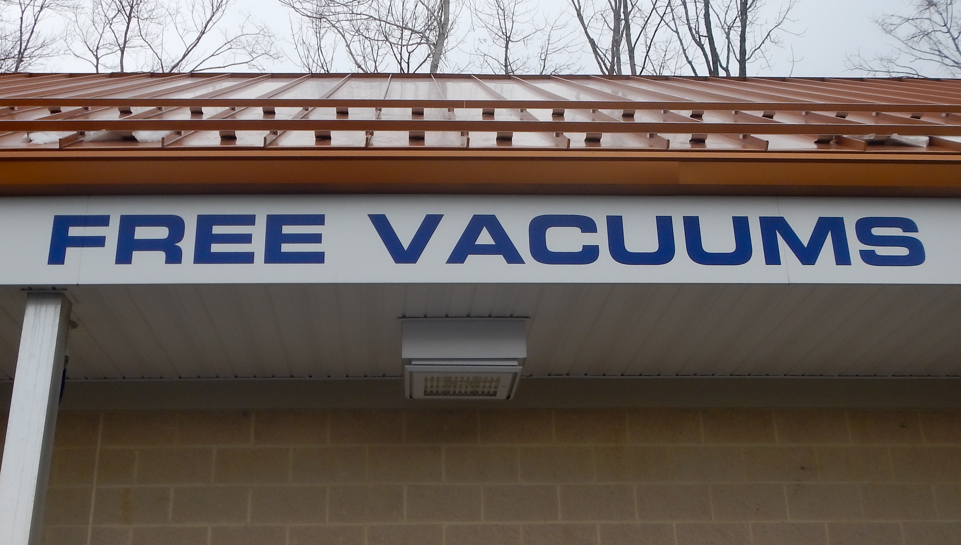 Blue vinyl lettering on the exterior of a car wash