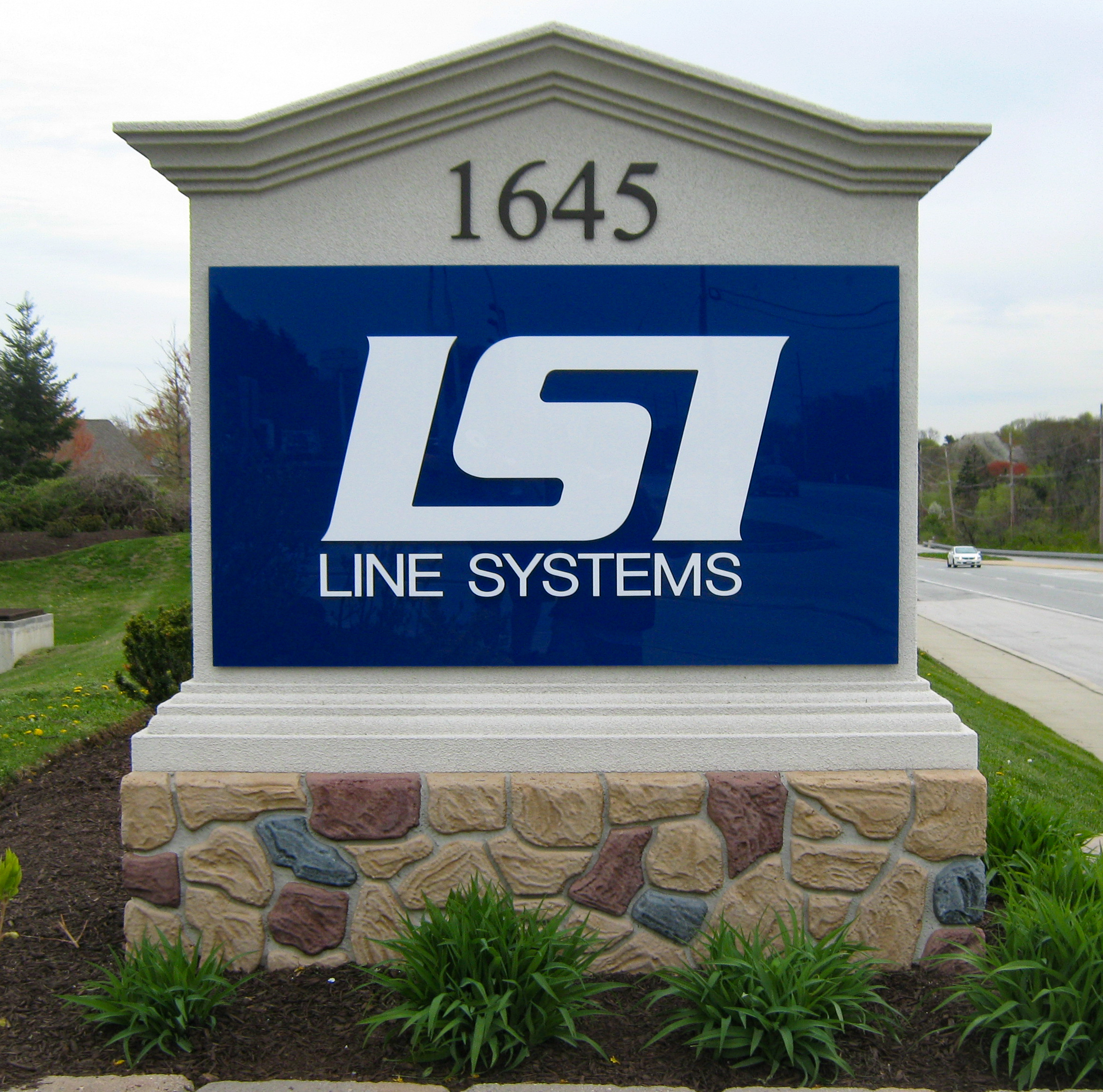 Vinyl on acrylic sign mounted on a fuax-stone foam base