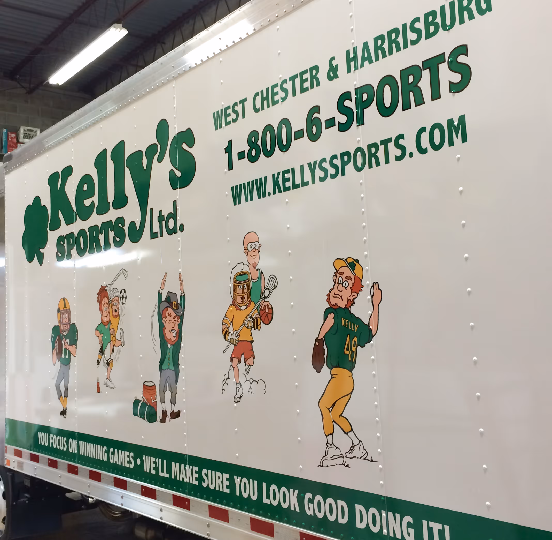 Green lettering and graphics on a large box truck