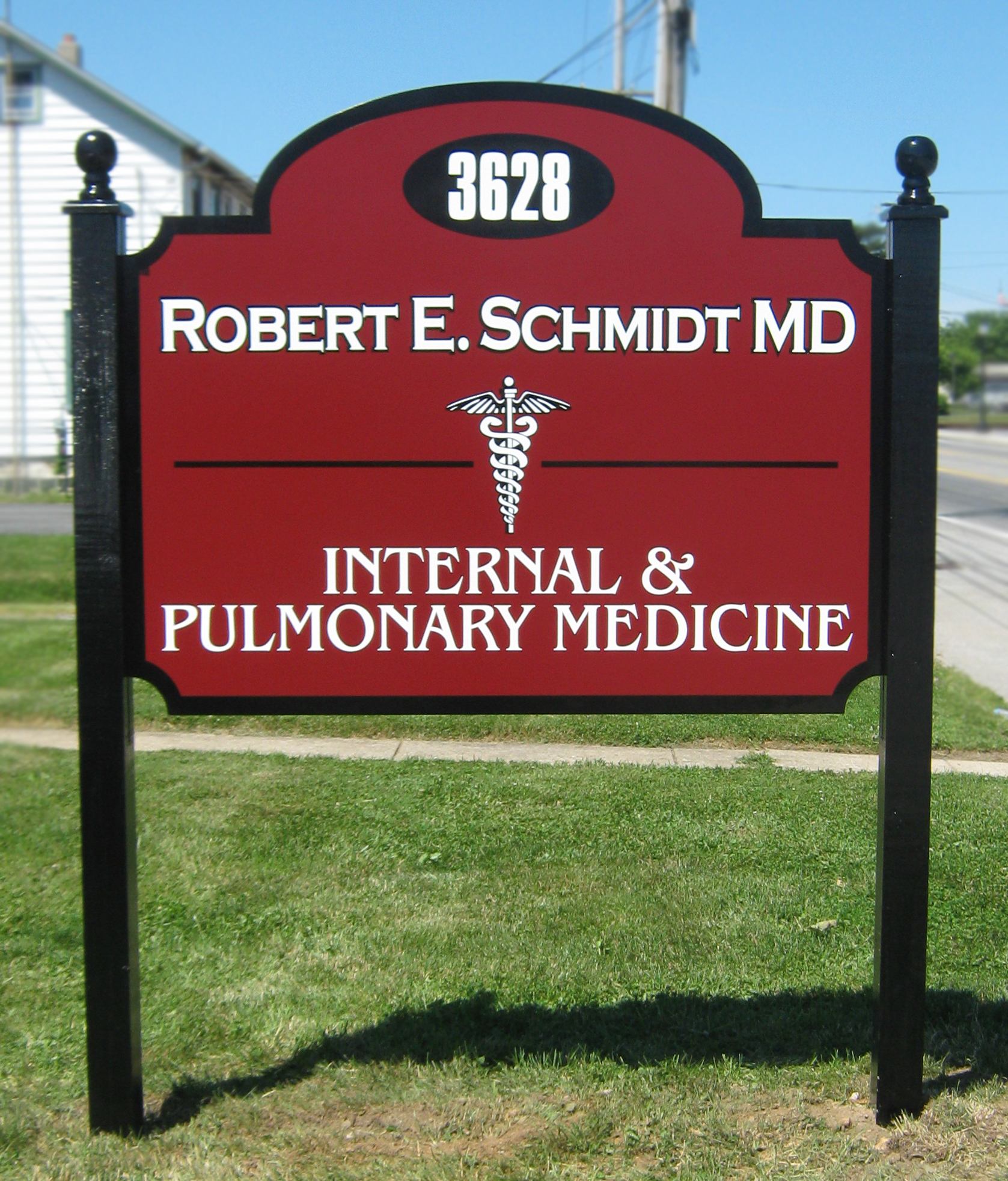 Post and panel monument sign with black posts and ball finials