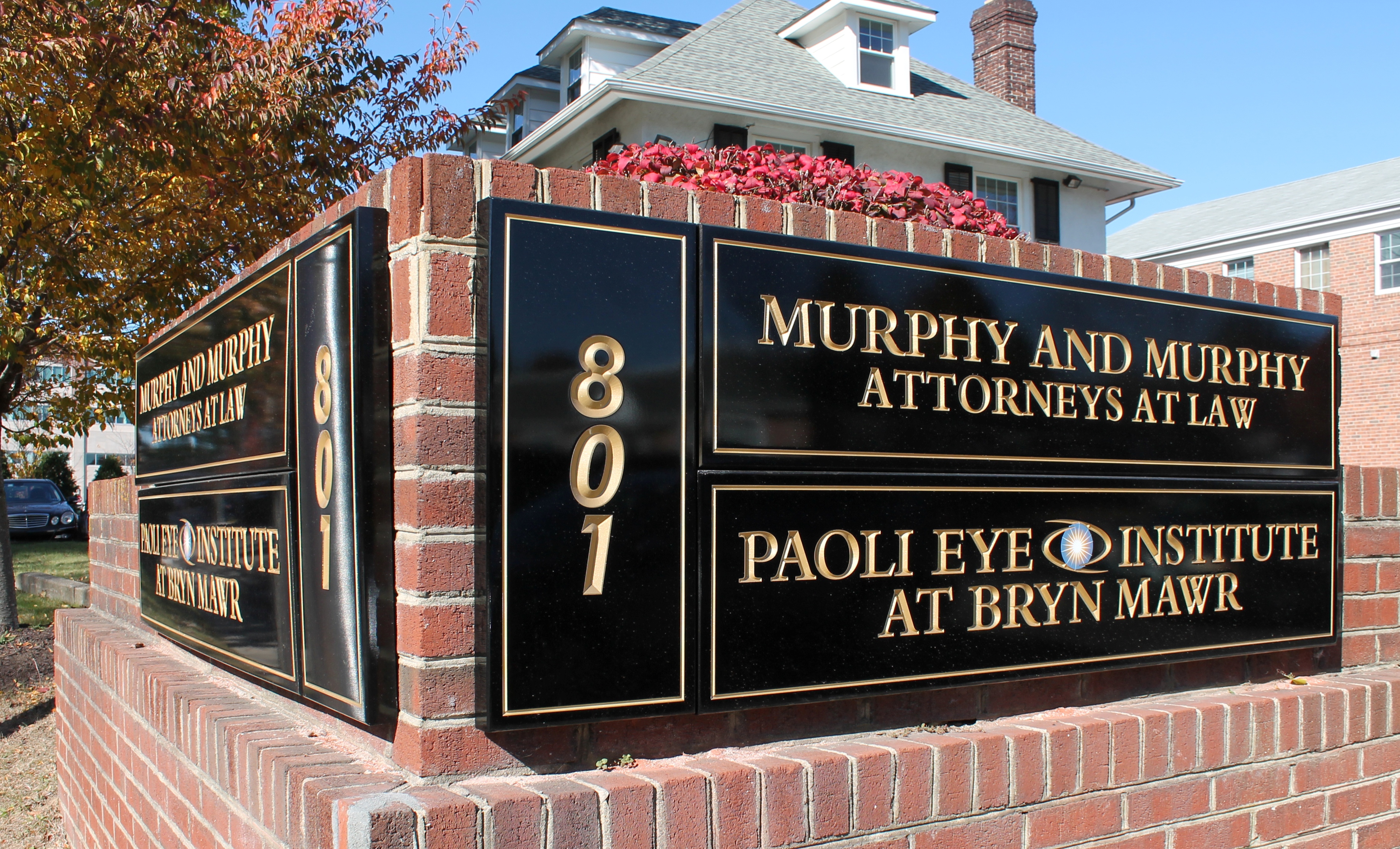 Brick monument with carved HDU signs on two sides