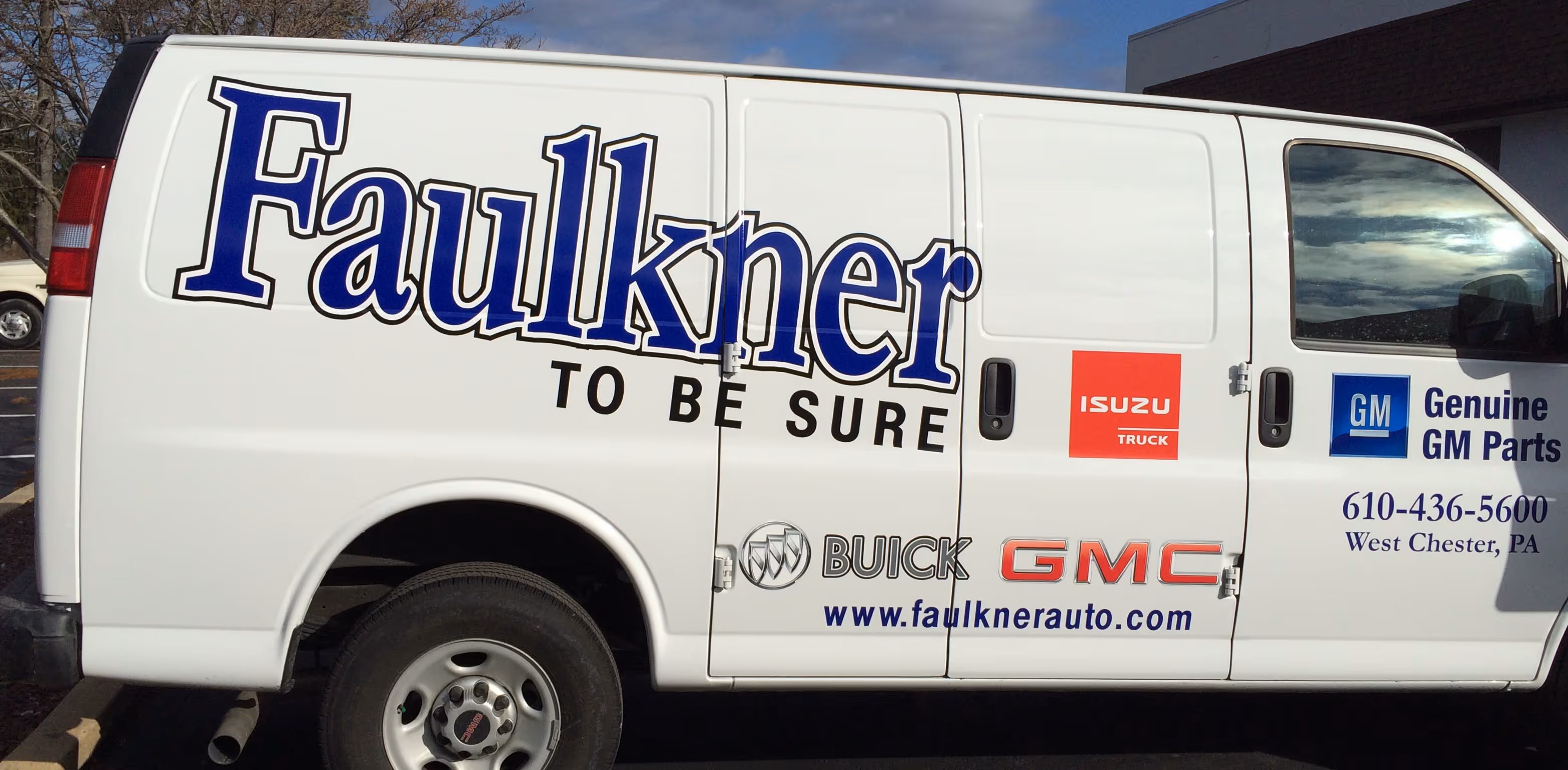 Car dealer vinyl branding on a panel van