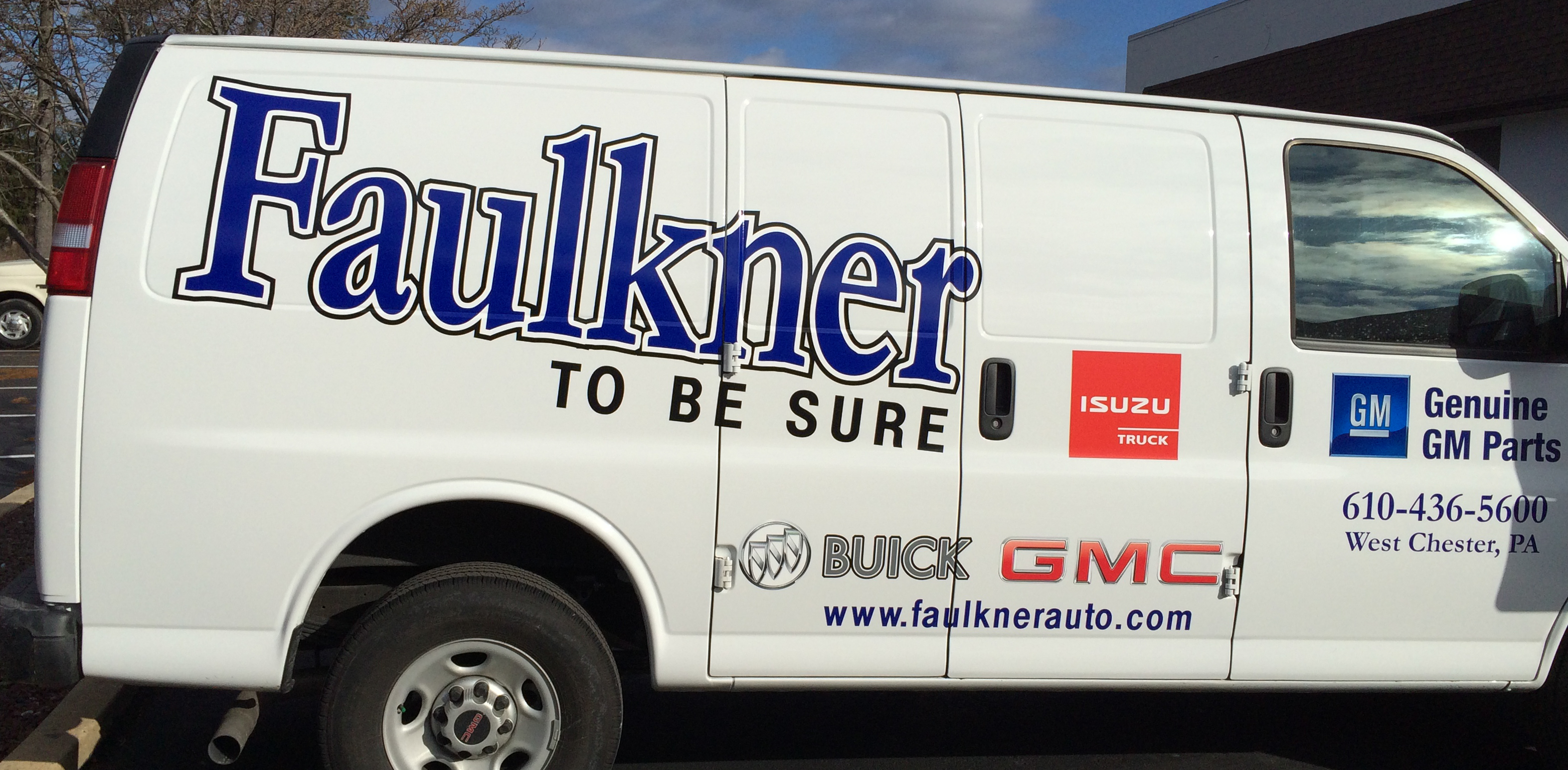 Car dealer vinyl branding on a panel van