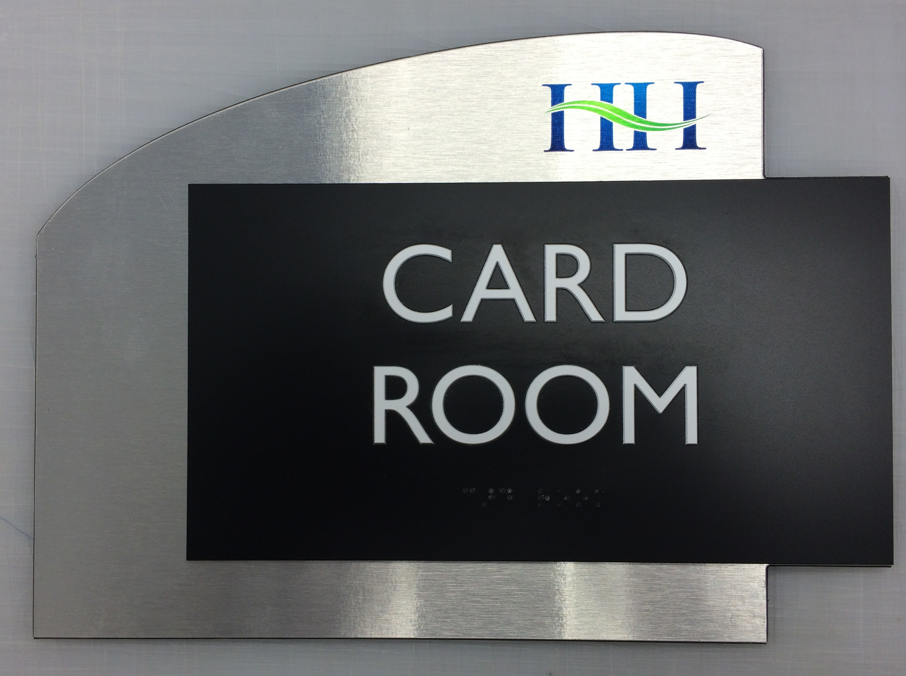 Custom ADA room sign mixing brushed aluminum with black acrylic