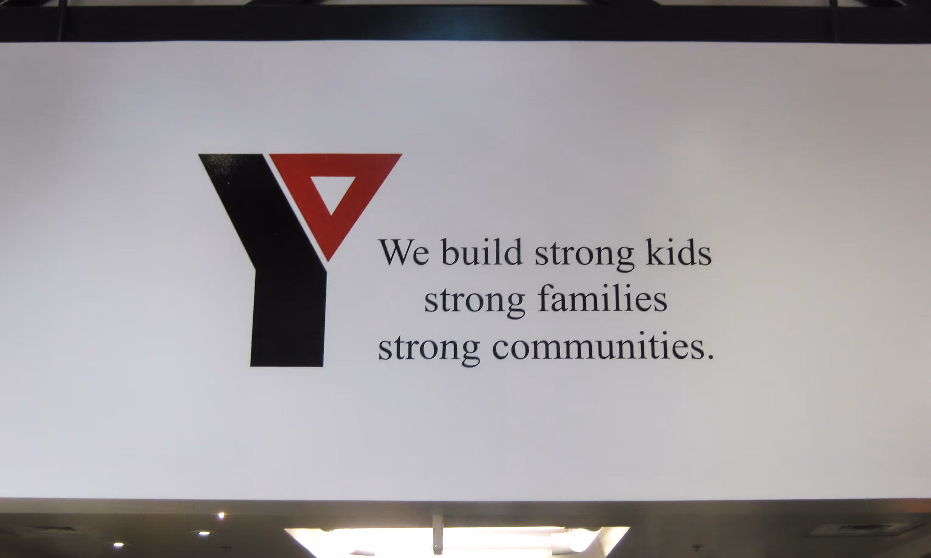 Vinyl lettering and logo on a white wall