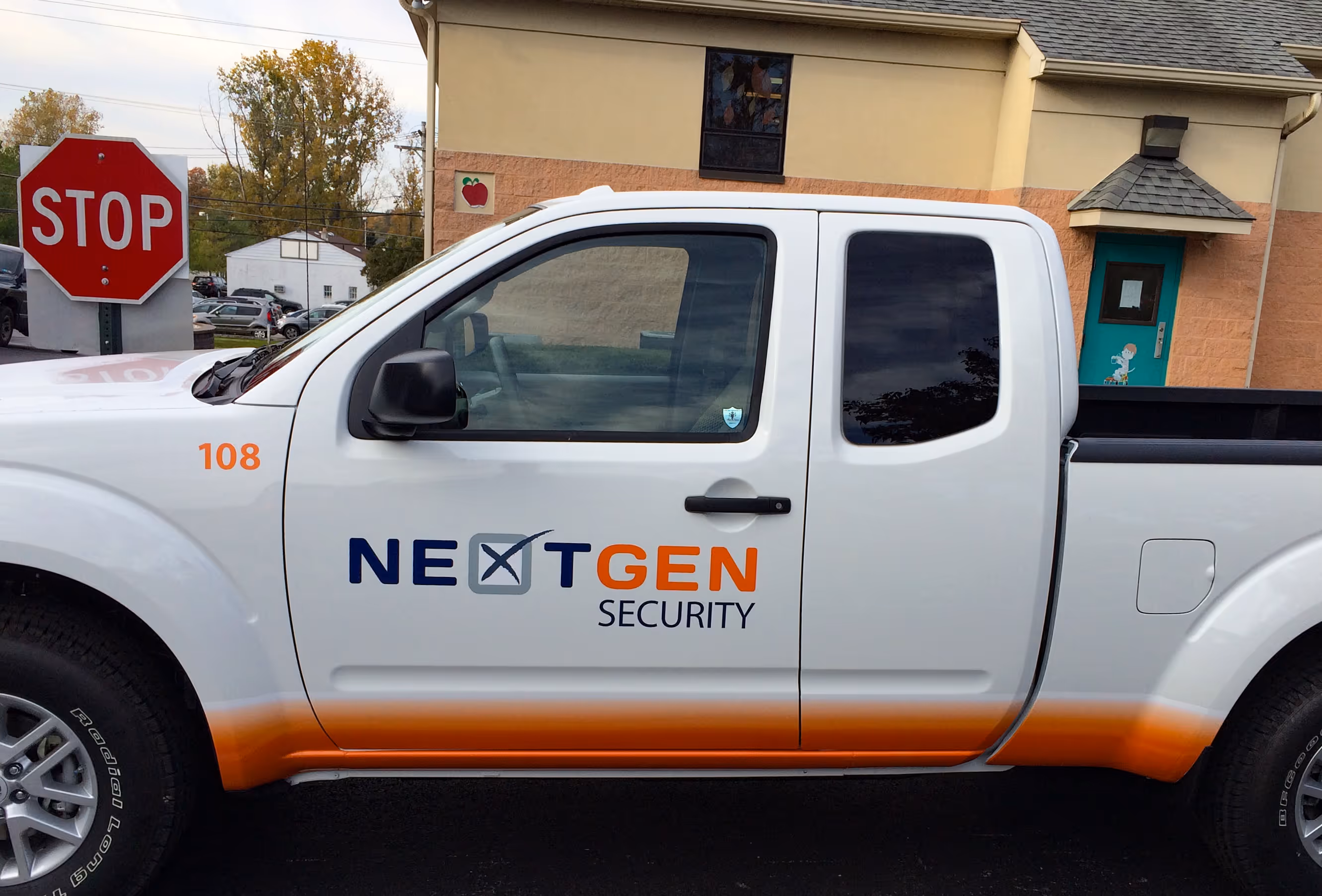 Orange and black vehicle wrap on a pickup truck