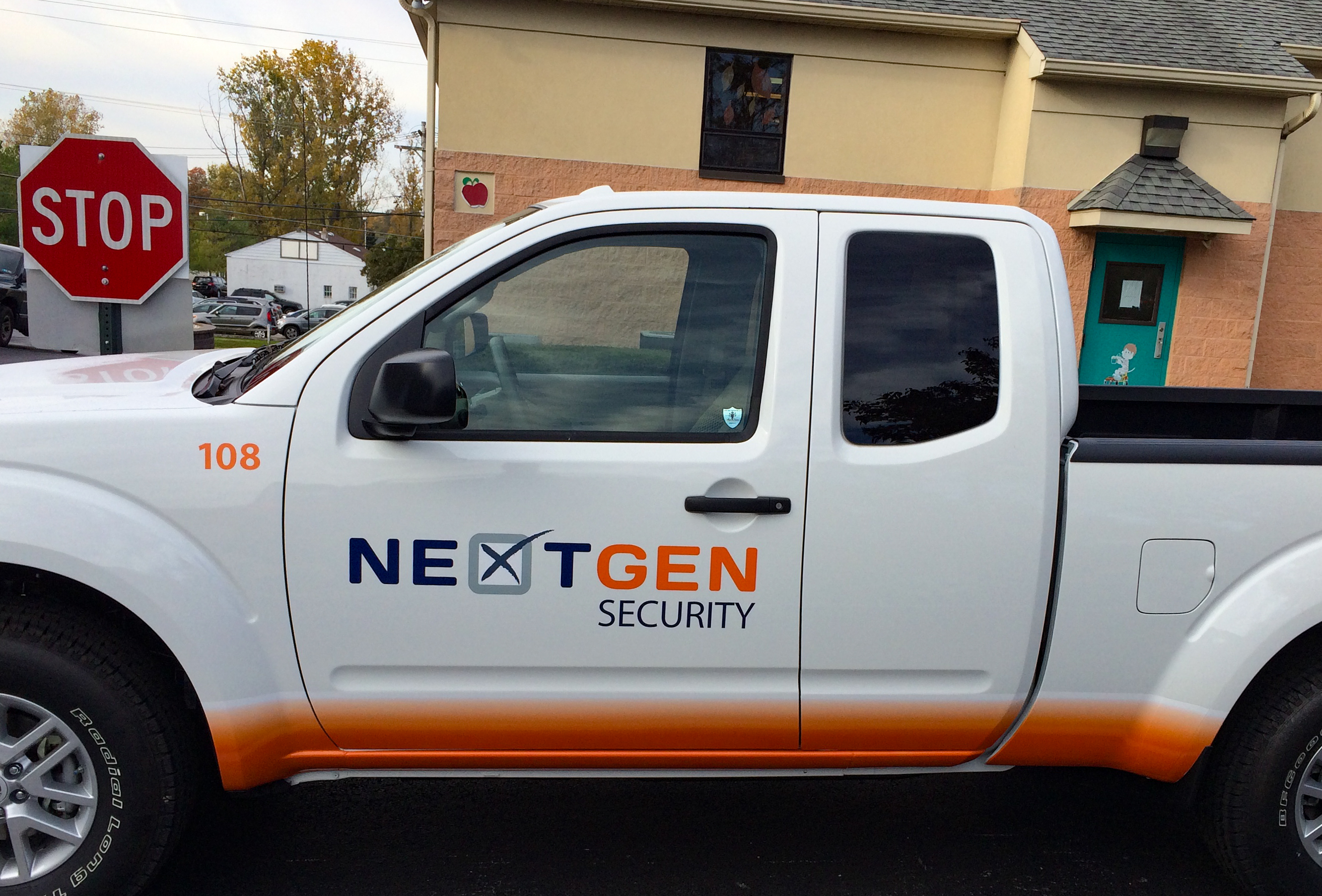 Orange and black vehicle wrap on a pickup truck
