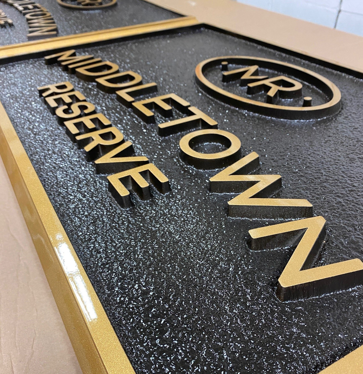 Gold and black carved HDU sign for a housing development