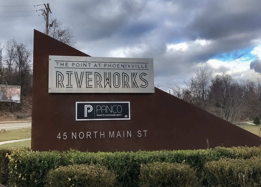 Triangular monument sign with large routed aluminum panel