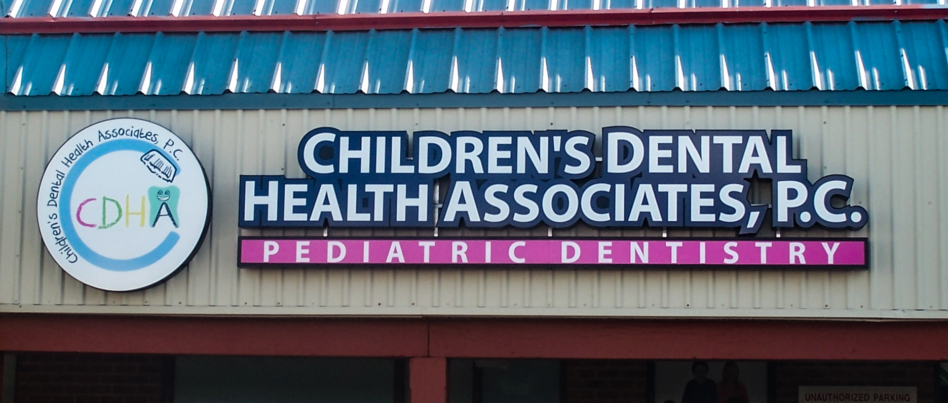 Multi-color channel letters and logo over a shopping center entrance