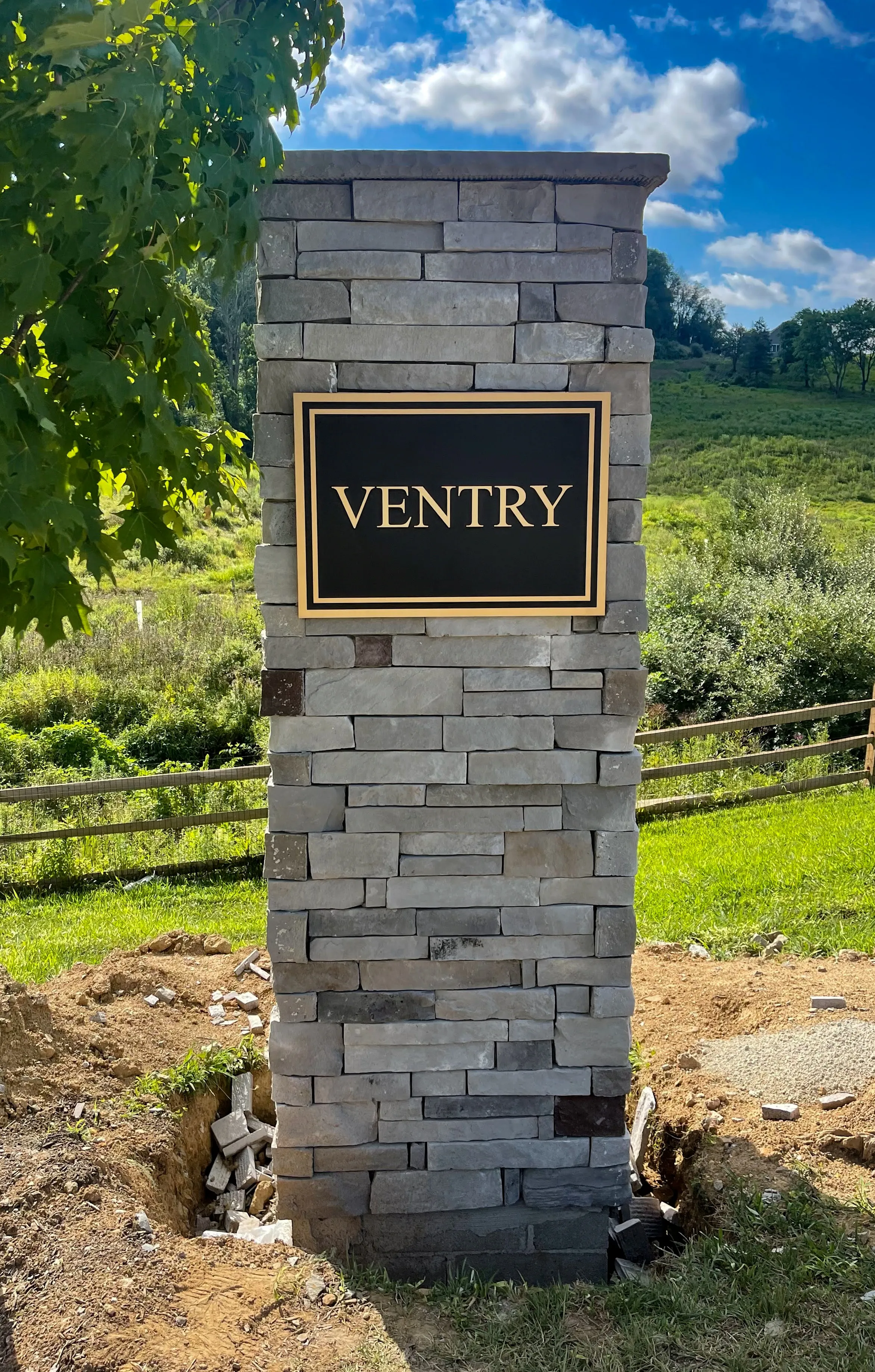 Precision-tooled bronze plaque mounted on a natural stone pillar