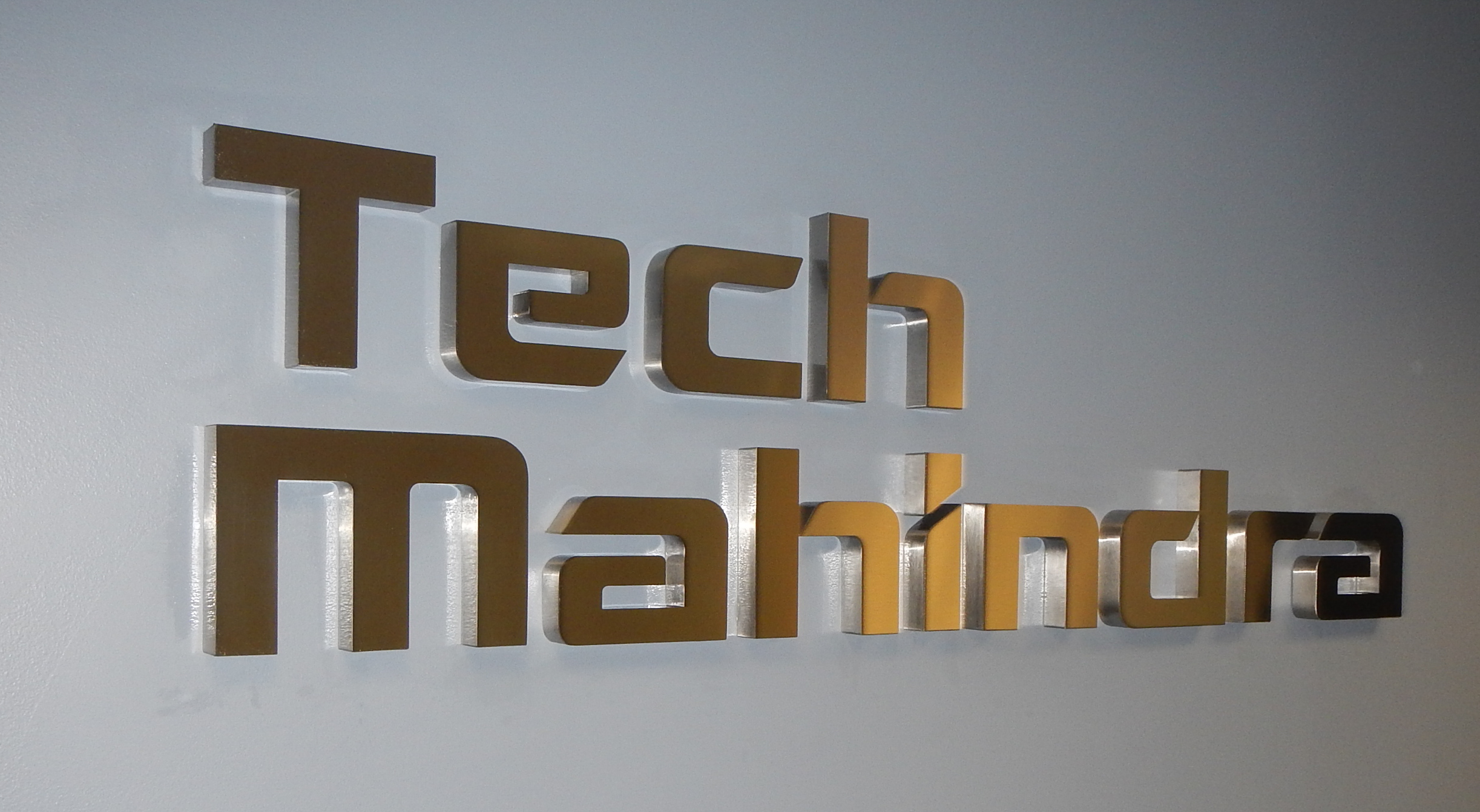 Gold-toned dimensional letters mounted flush to the wall