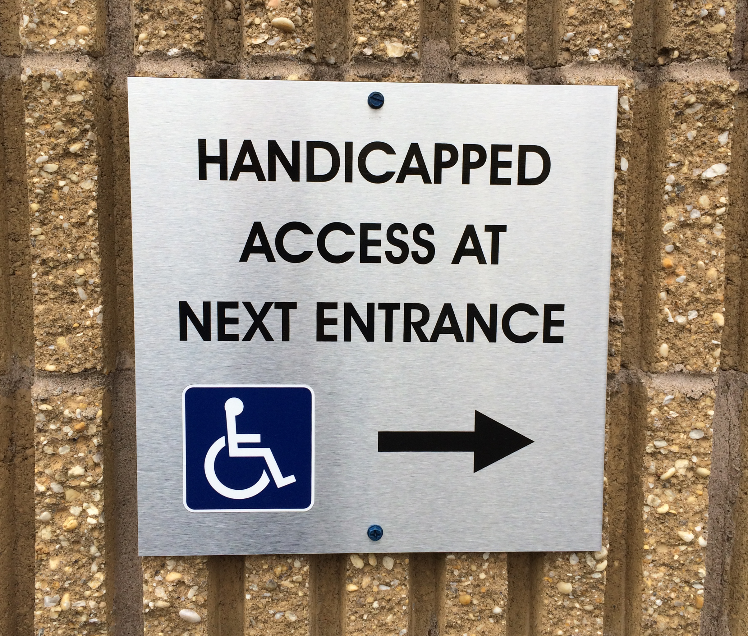 Directional sign made from plotted vinyl on a brushed aluminum panel