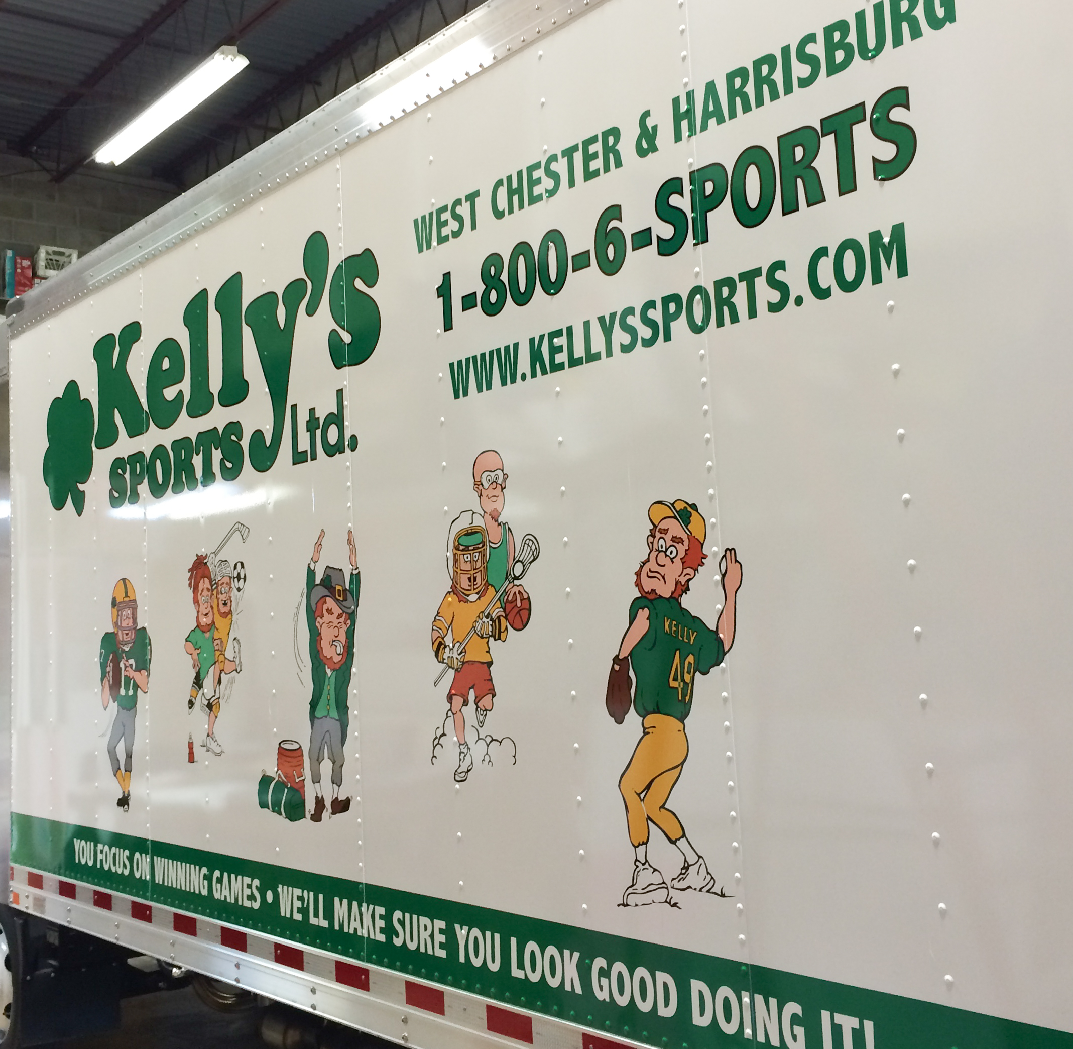 Custom vinyl graphics and lettering on the side of a large box truck