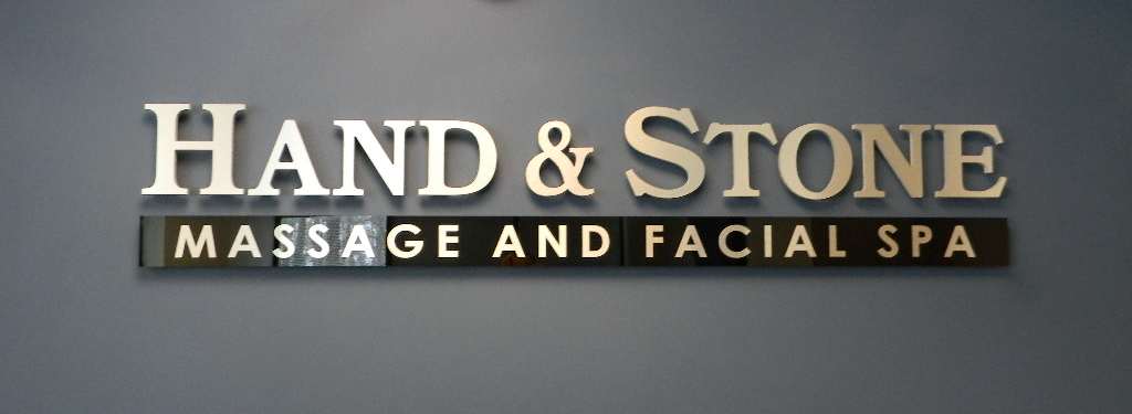 Acrylic dimensional letters and banner mounted on a gray wall