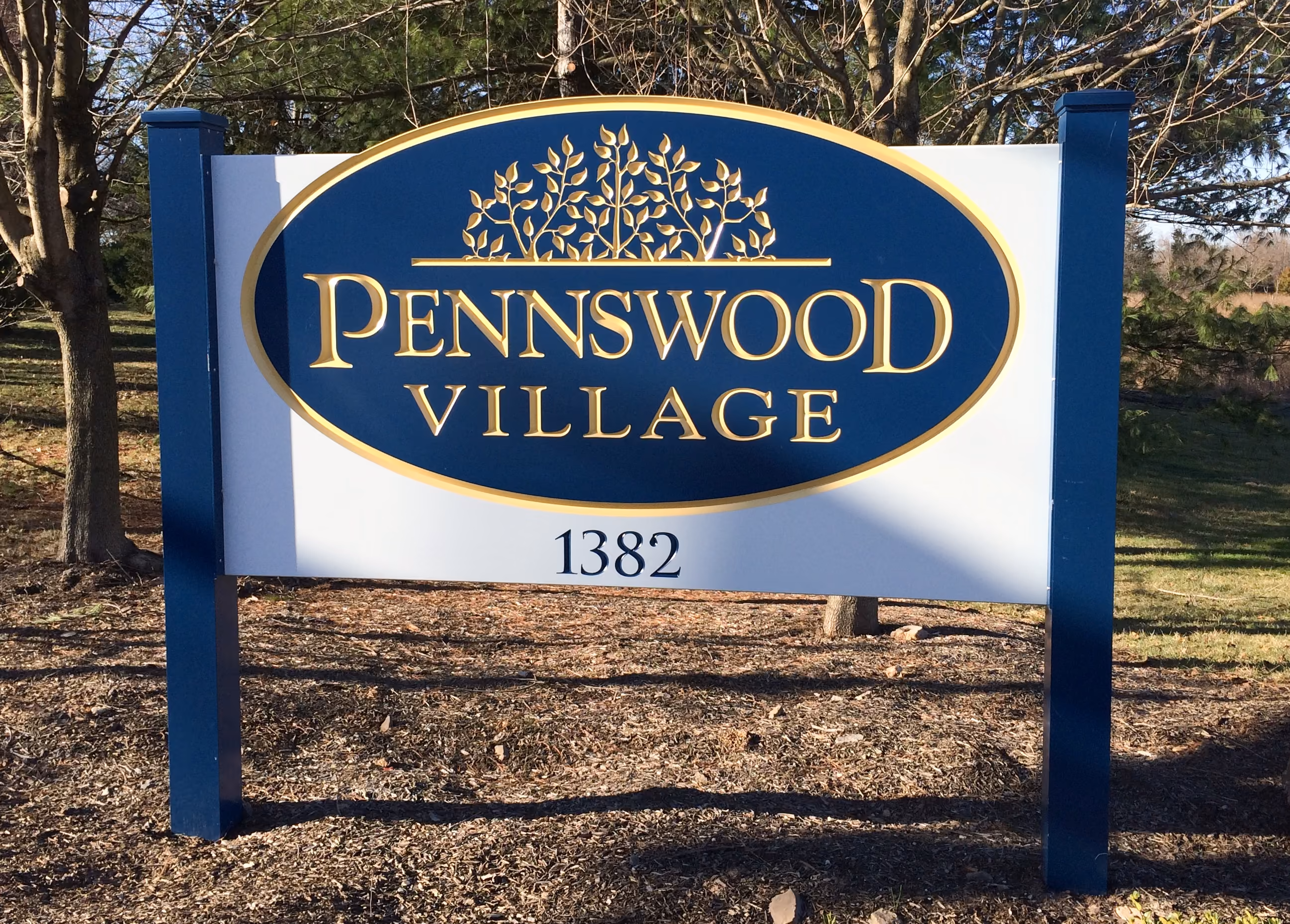 Gold, blue, and white carved HDU sign mounted on two posts