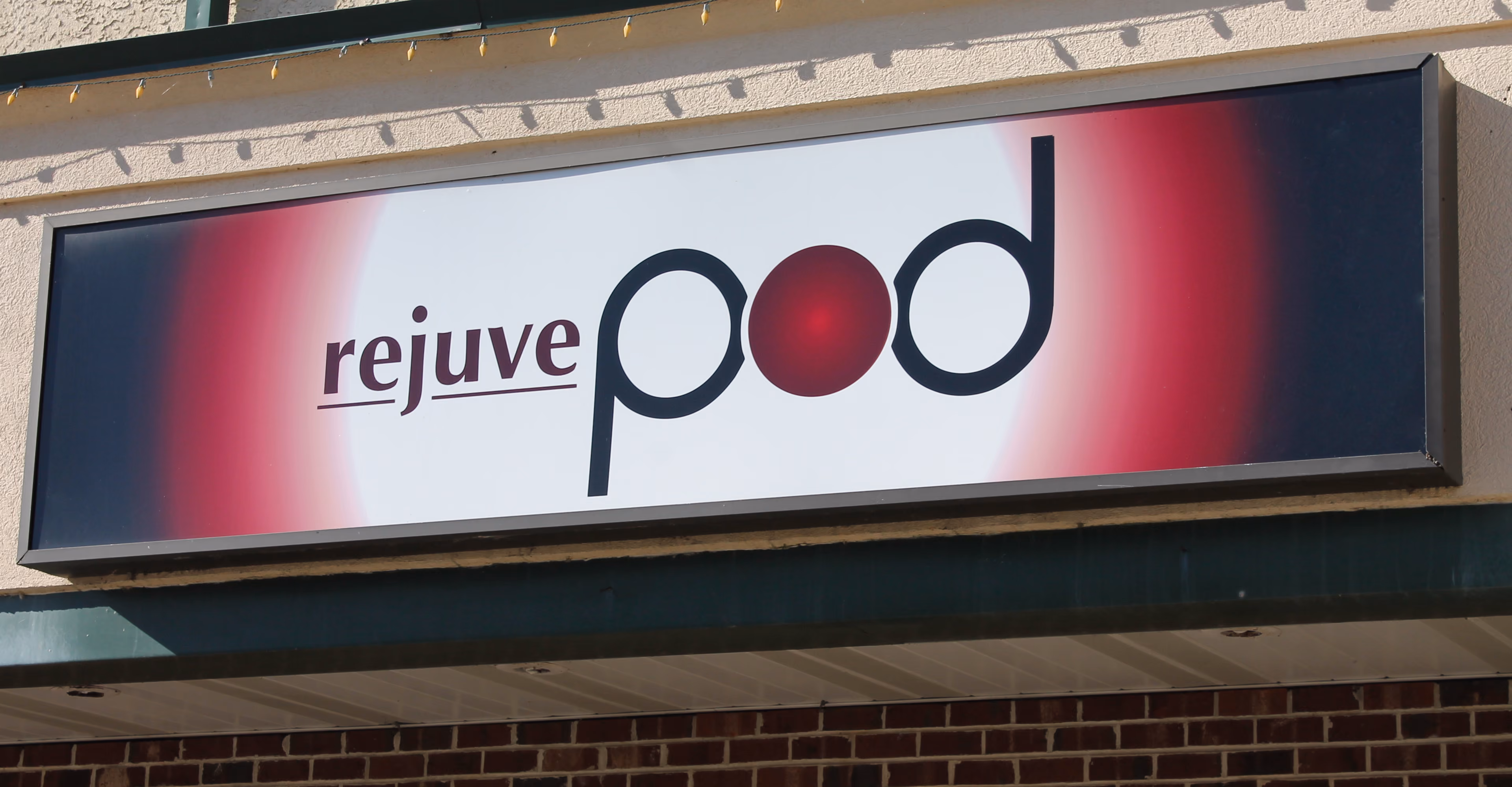 Rectangular lightbox with large branded company name on the face
