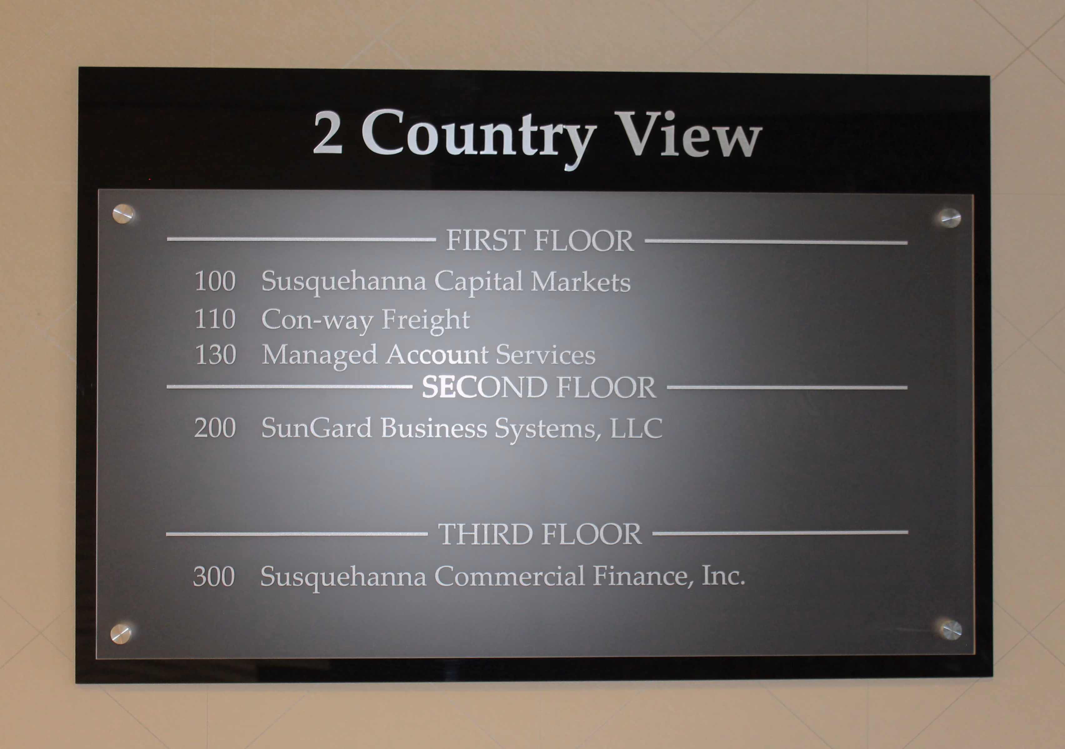 Building directory on frosted acrylic panel mounted on black backer