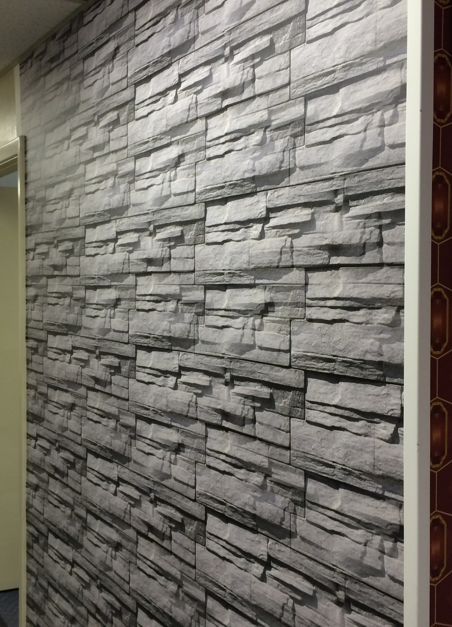 Large vinyl wall graphic depicting a stone wall