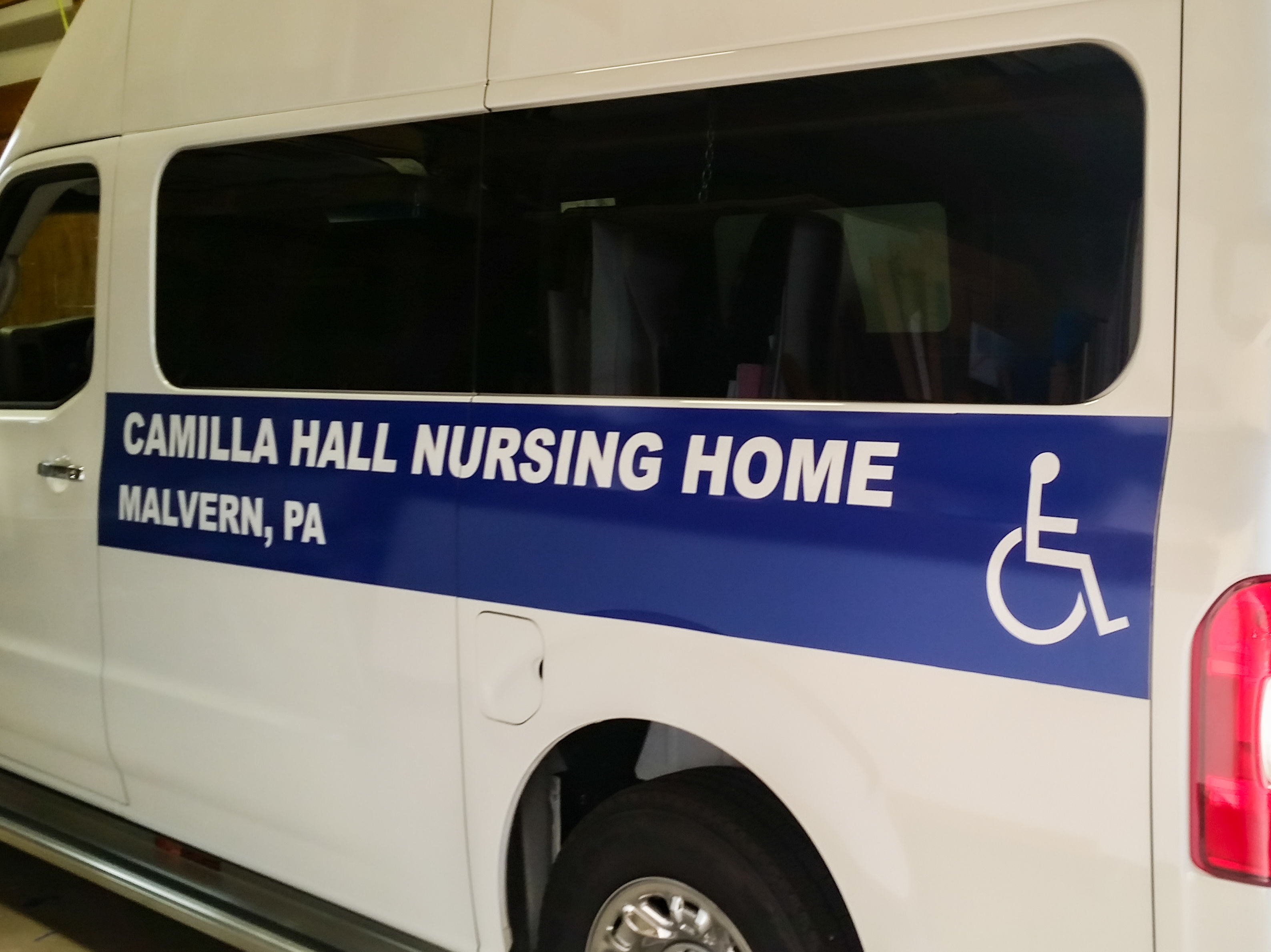 Blue handicap vinyl graphic on a patient transportation van