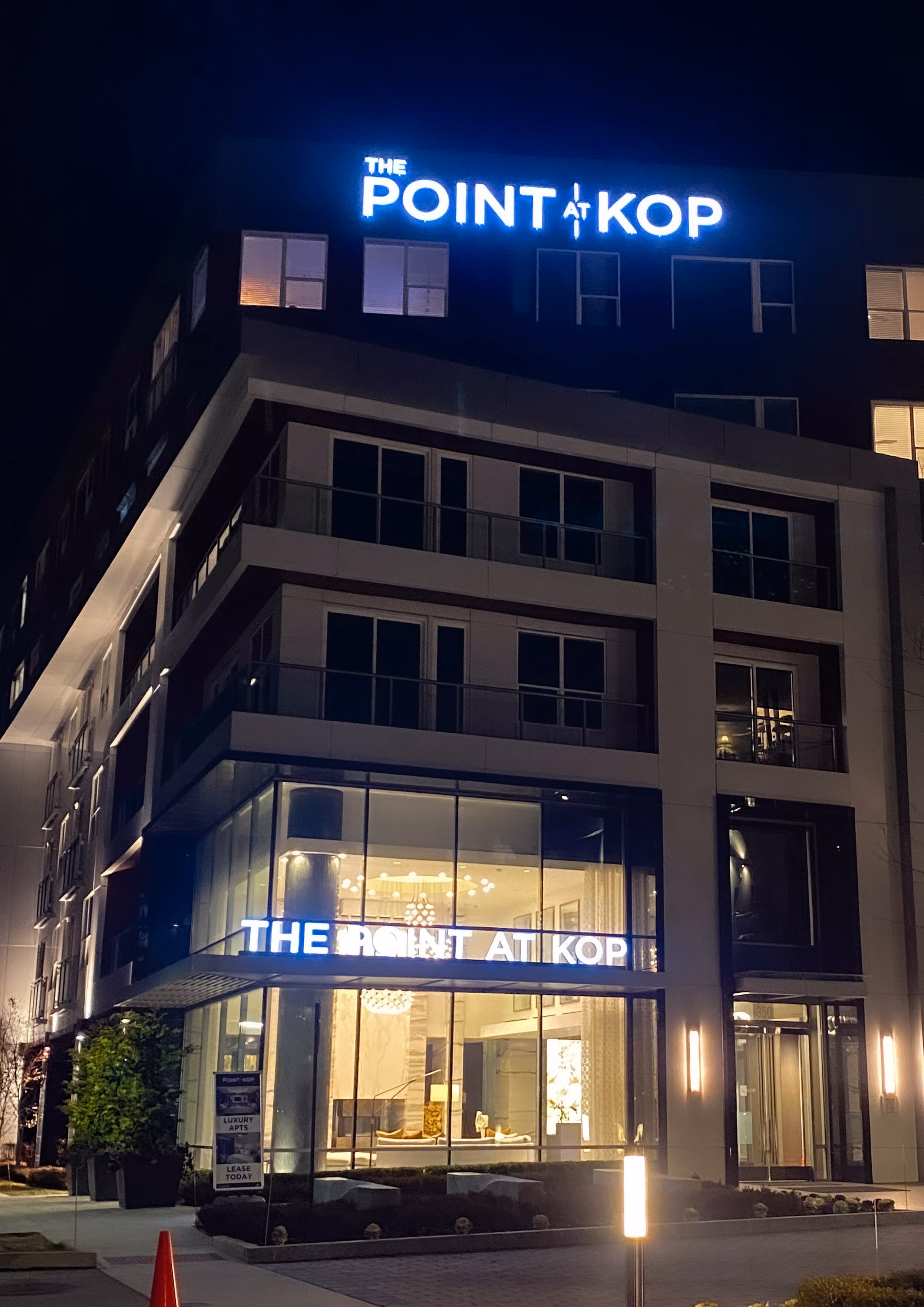 Blue channel letters atop a residential apartment building