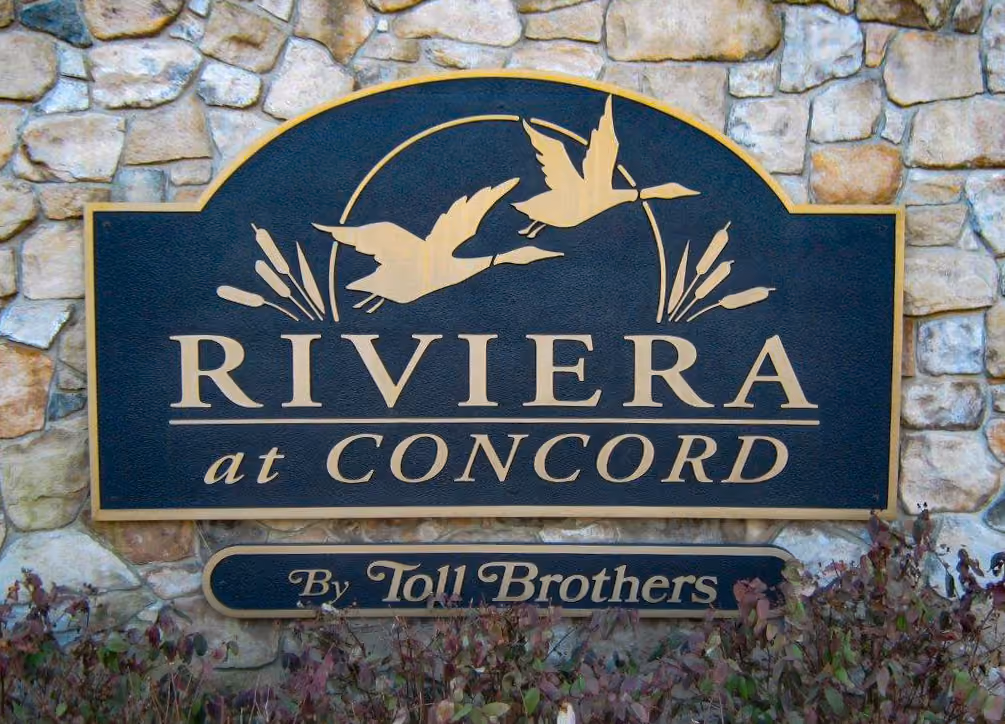 Carved HDU sign mounted on a natural stone monument base