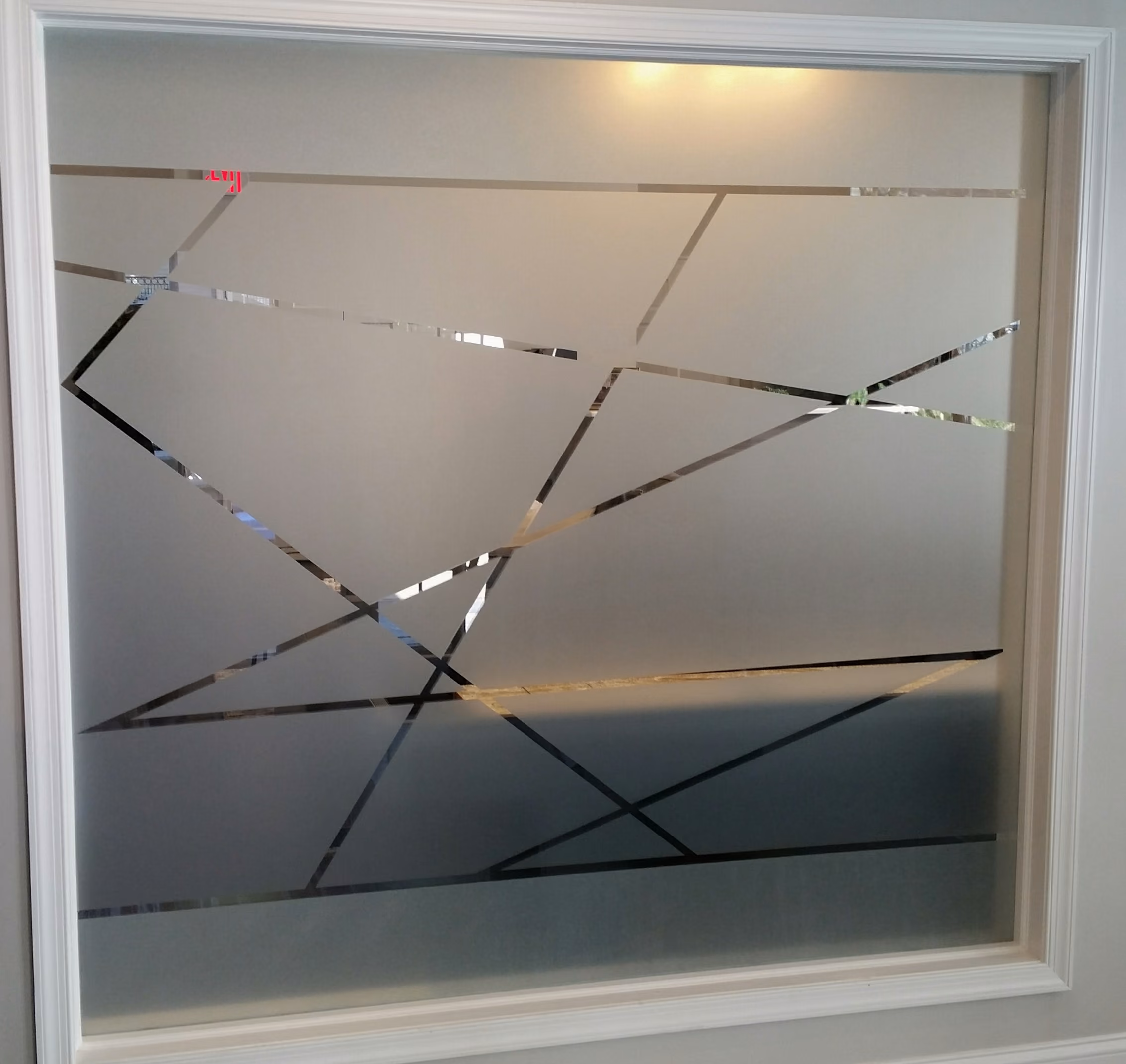 Custom-cut privacy vinyl on a glass office wall