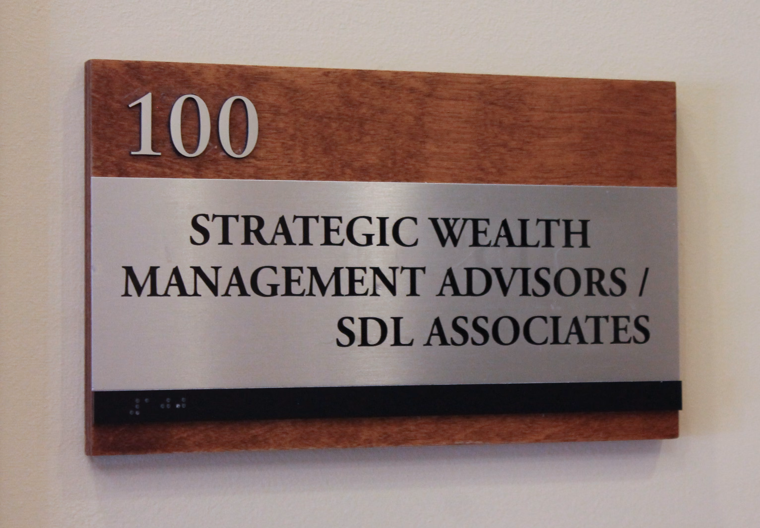 Custom ADA room sign with wood tones and brushed aluminum