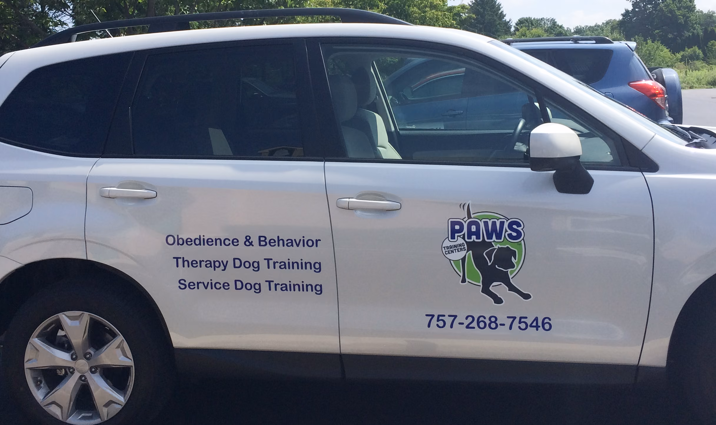 Vinyl lettering and logo on the side of an SUV