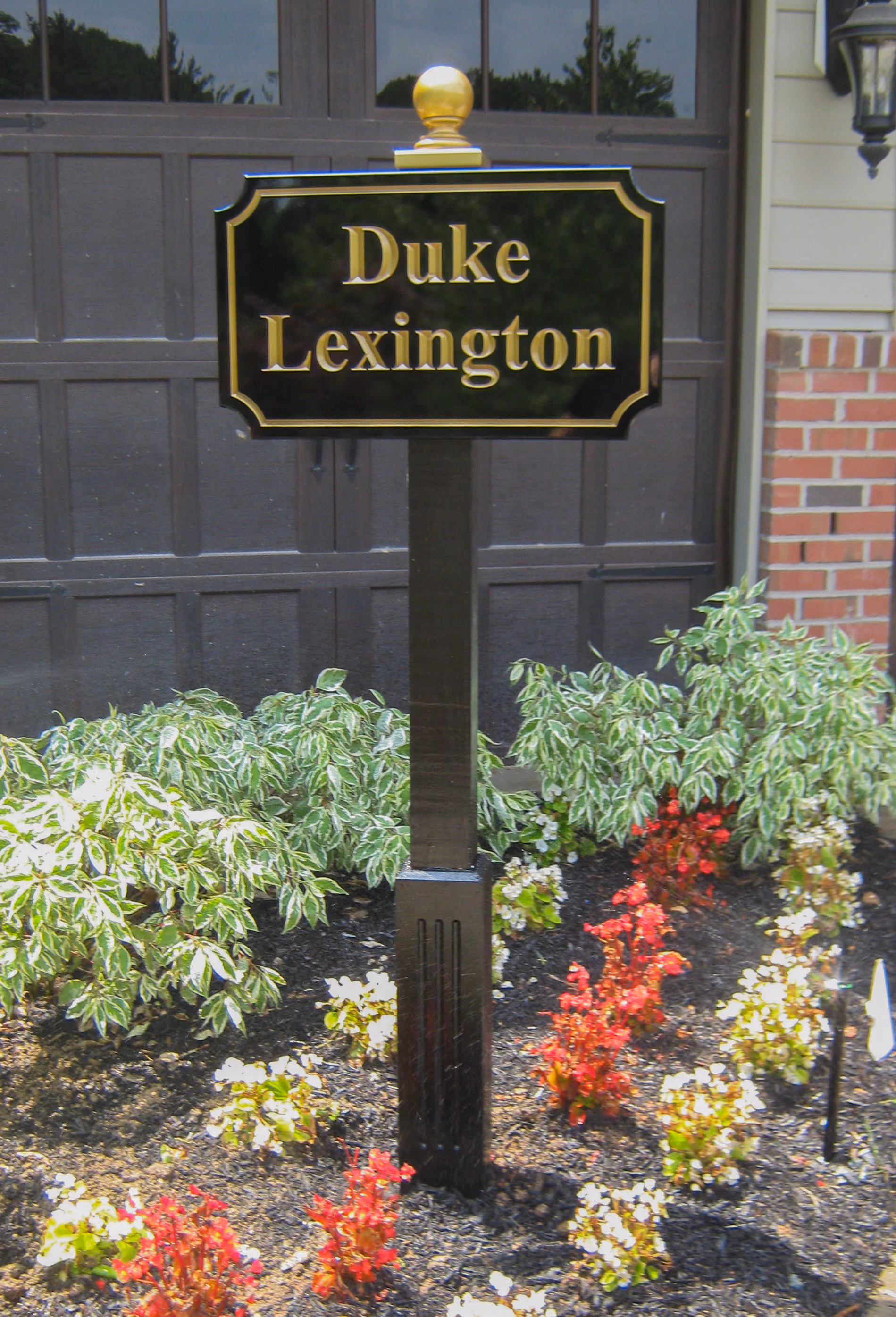 Carved HDU sign on a single post with a gold ball finial