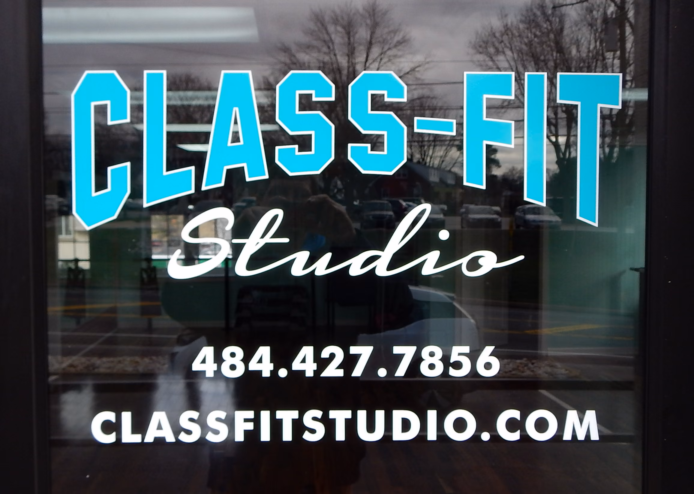 Custom vinyl lettering on the entryway to a fitness studio