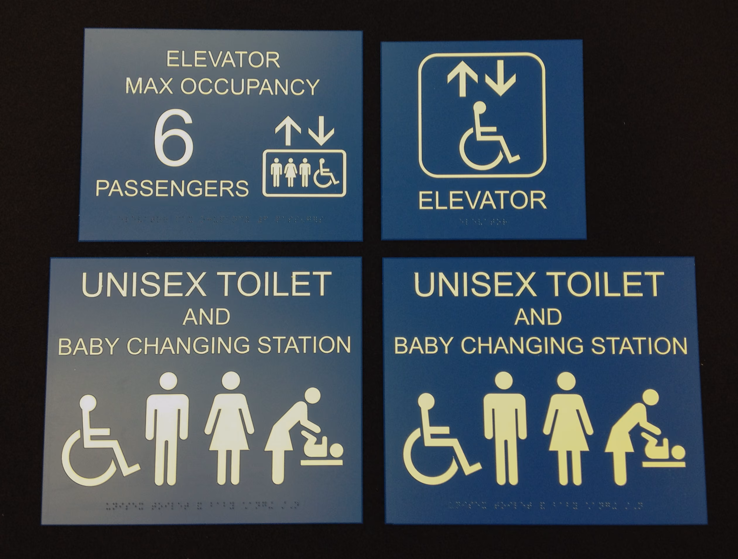 Blue ADA signs for elevators and restrooms