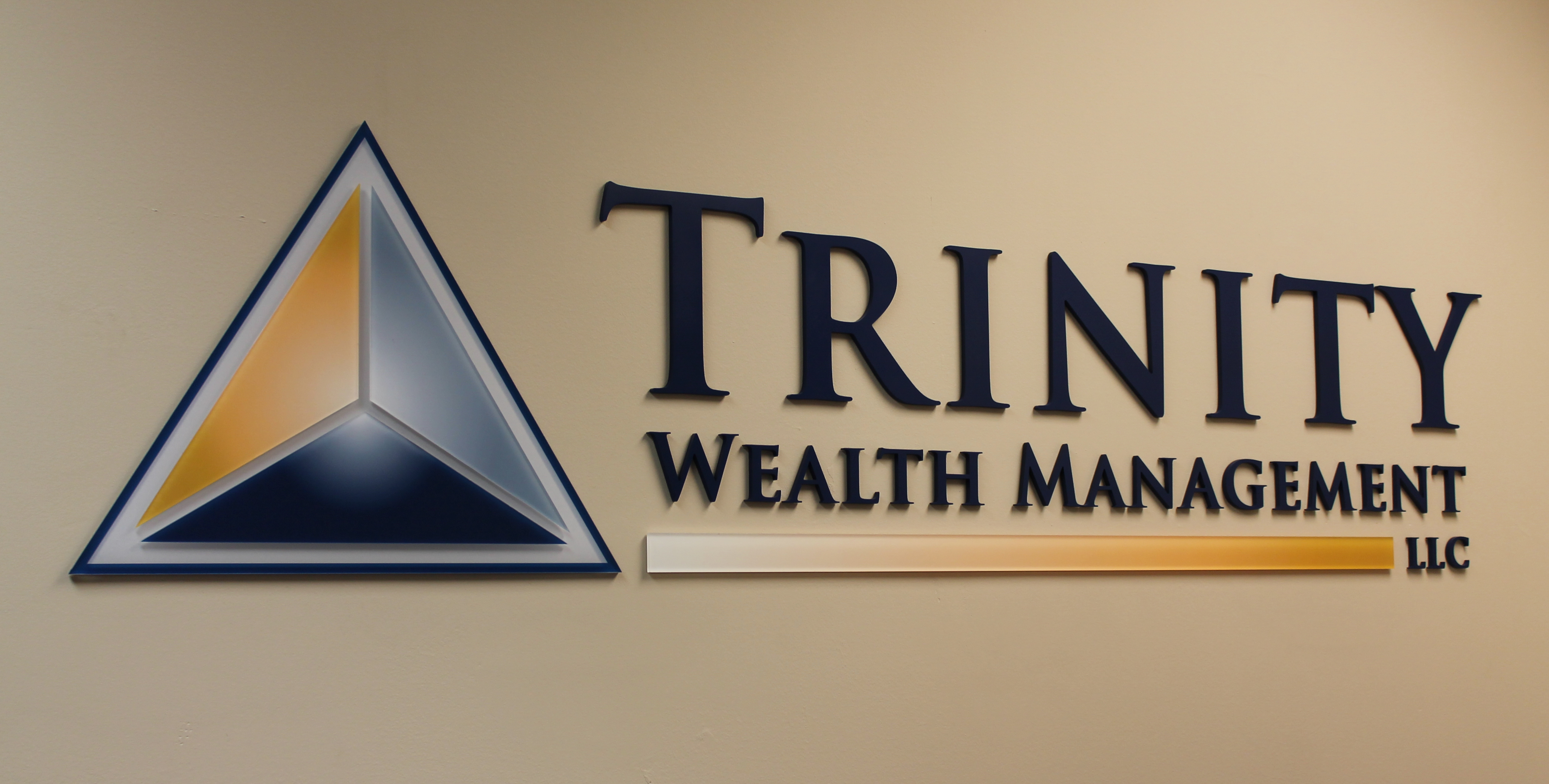 Multi-colored, acrylic dimensional letters and logo mounted flush to the wall