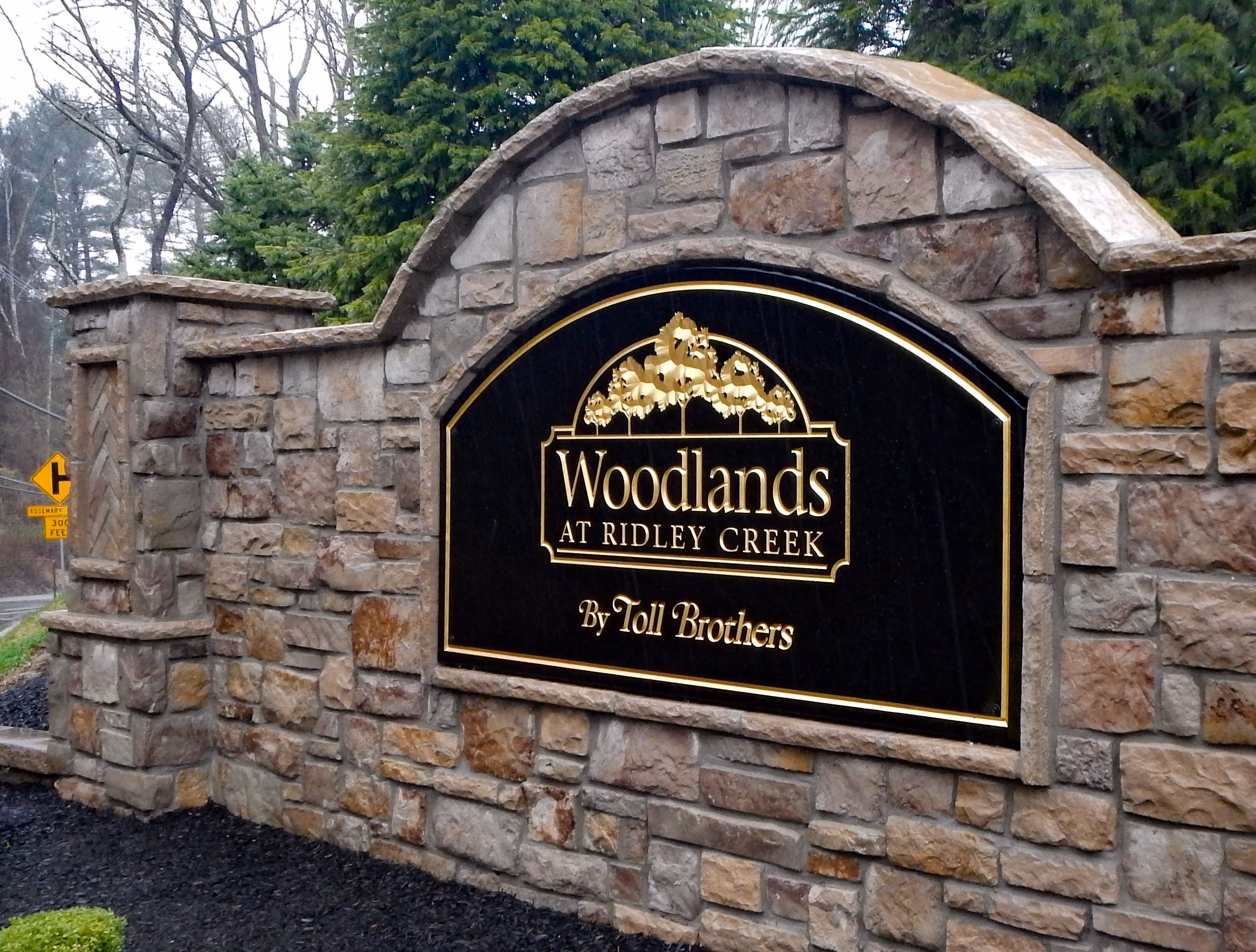 Large stone entrance monument with a carved HDU sign