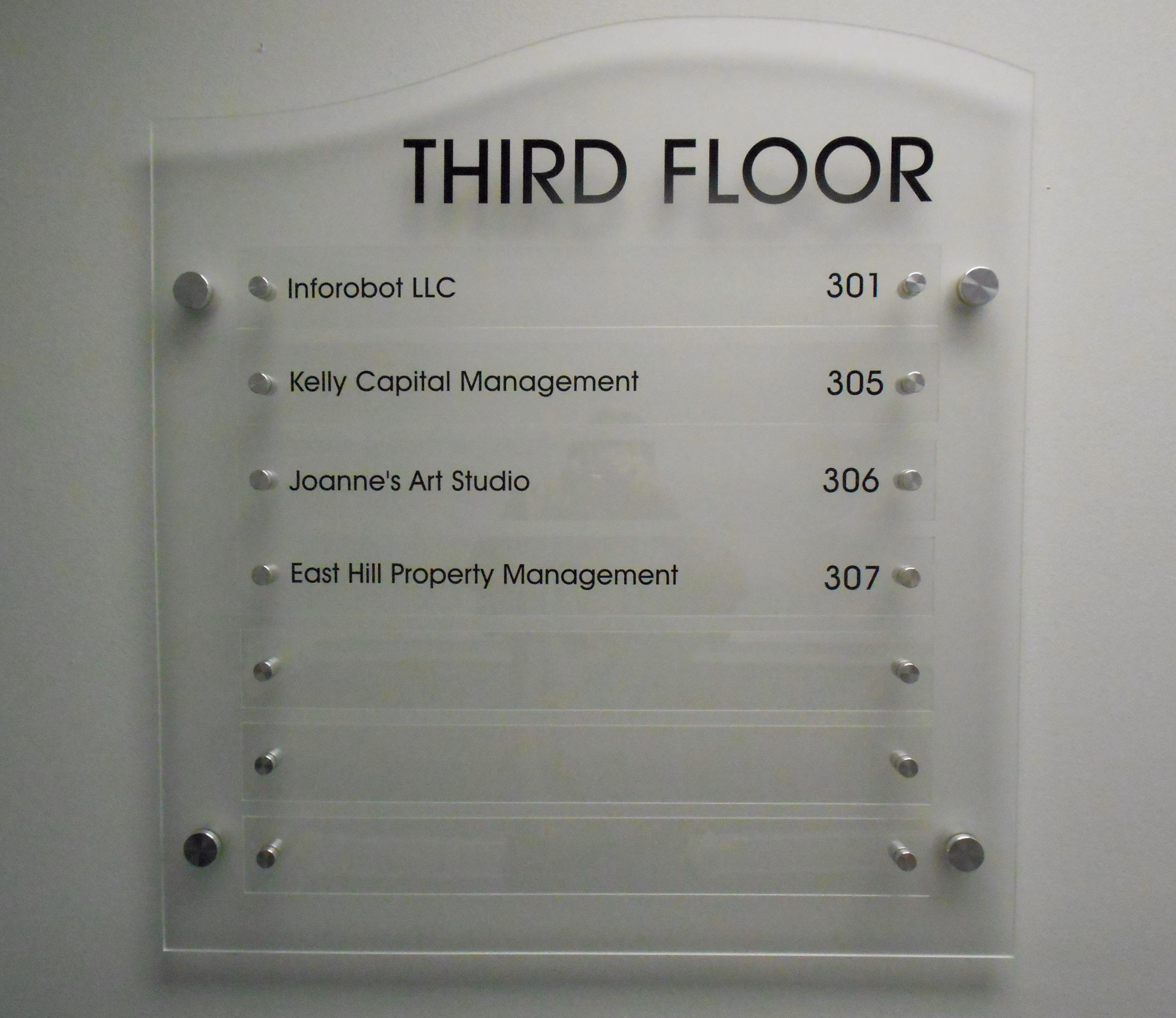 Building directory sign with clear acrylic mounted on standoffs